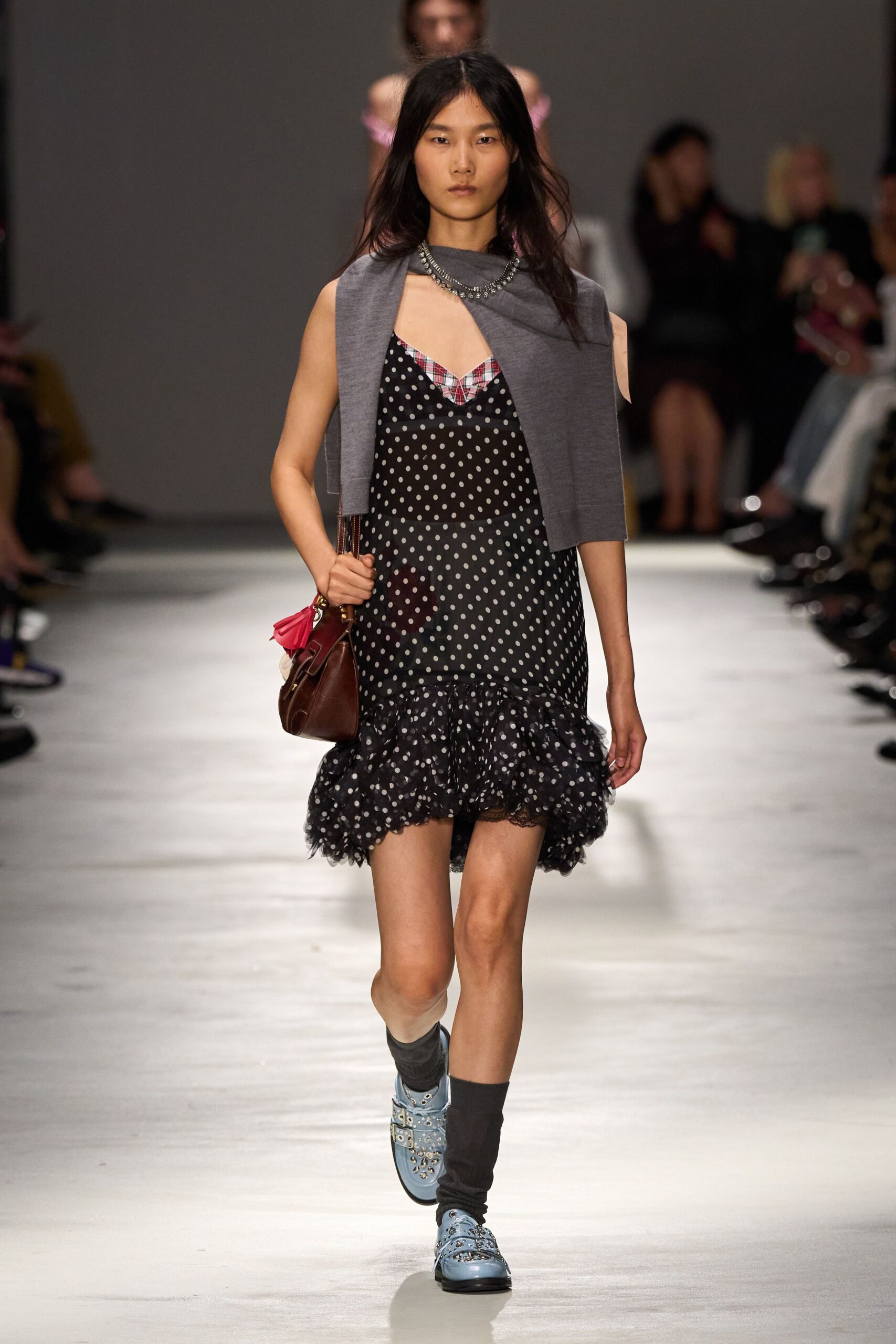 black polka-dot mini dress with gray sweater