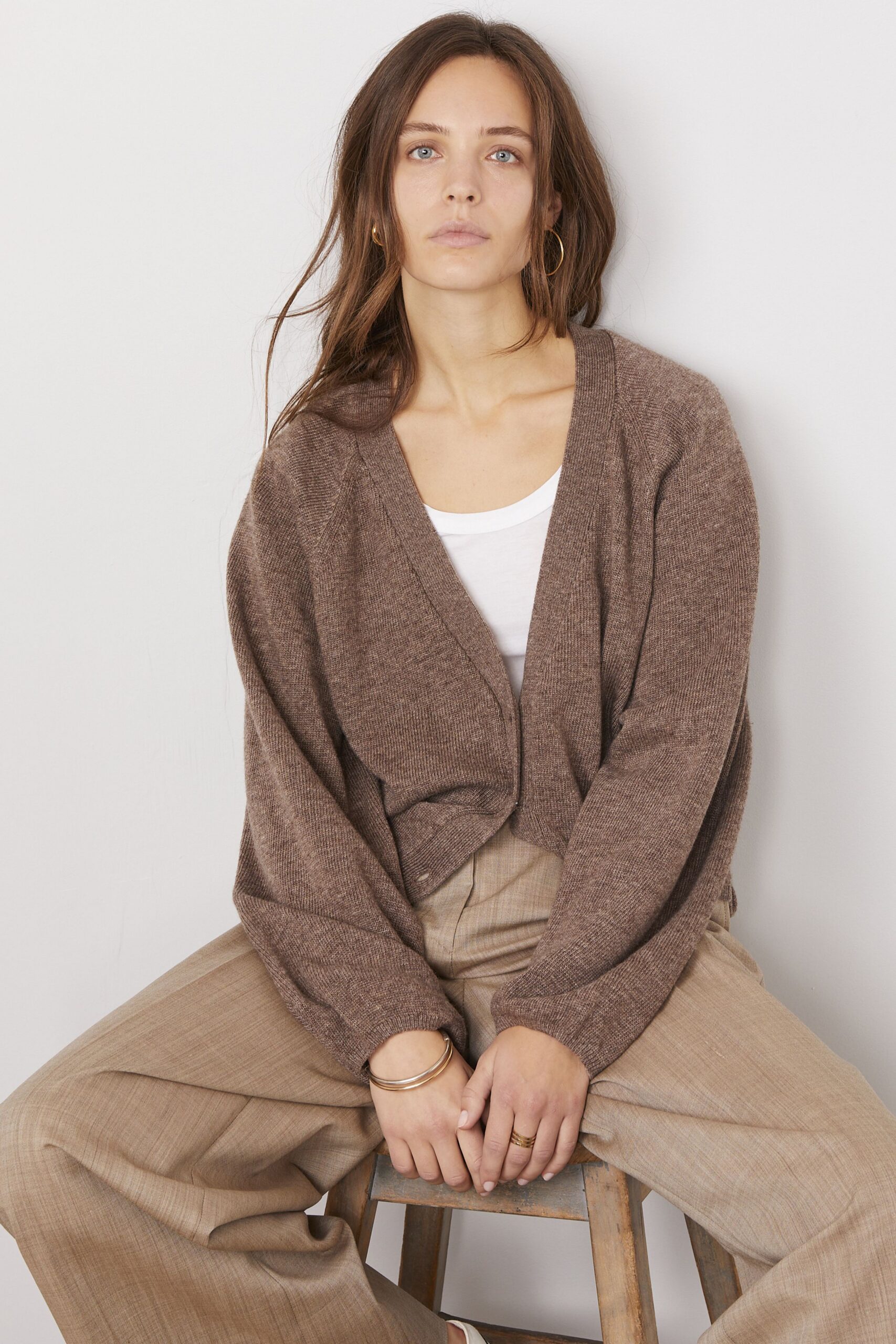 brown cardigan with white top and beige pants