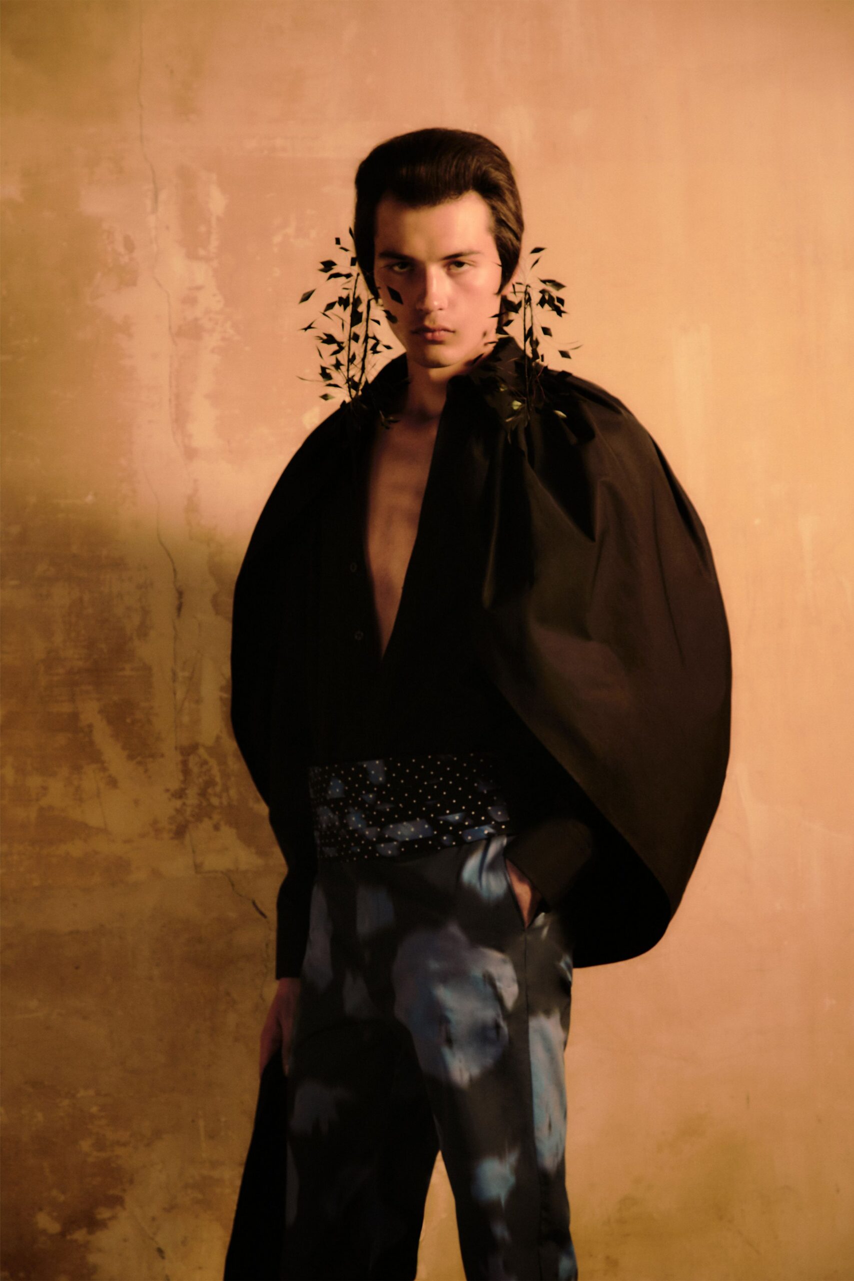 black cape with fitted shirt and flared pants