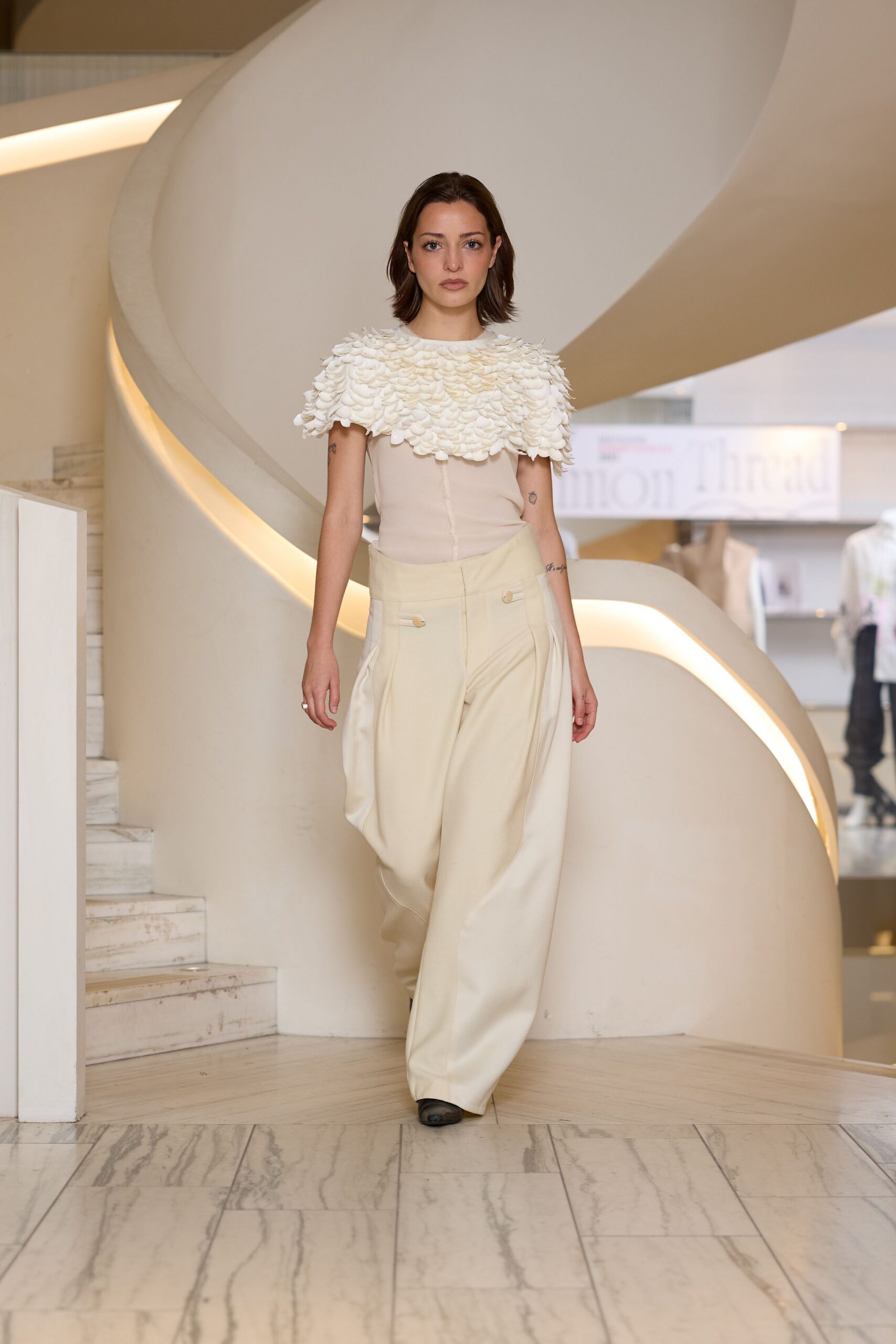 white ruffled top beige pants