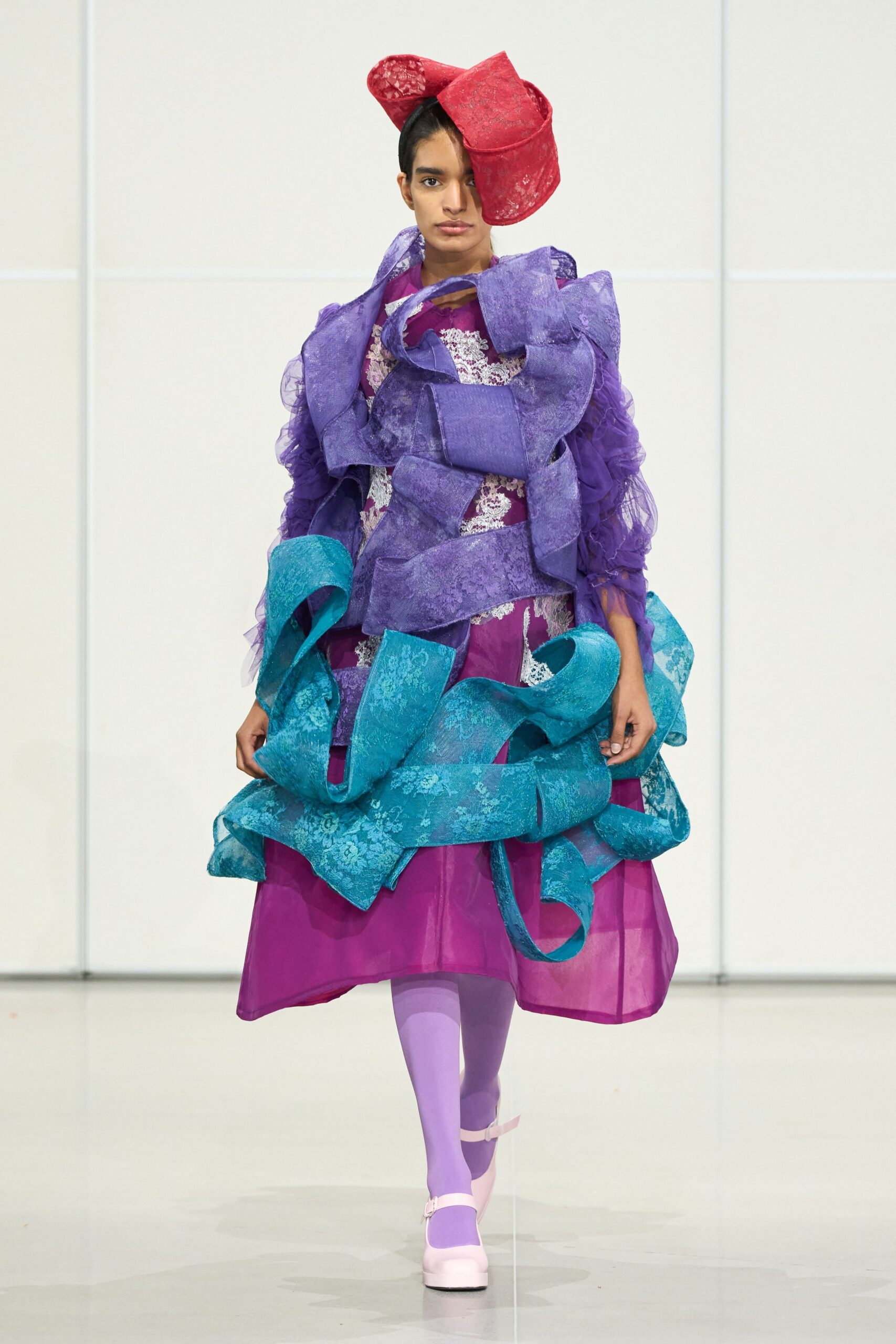 purple and pink layered dress with red hat
