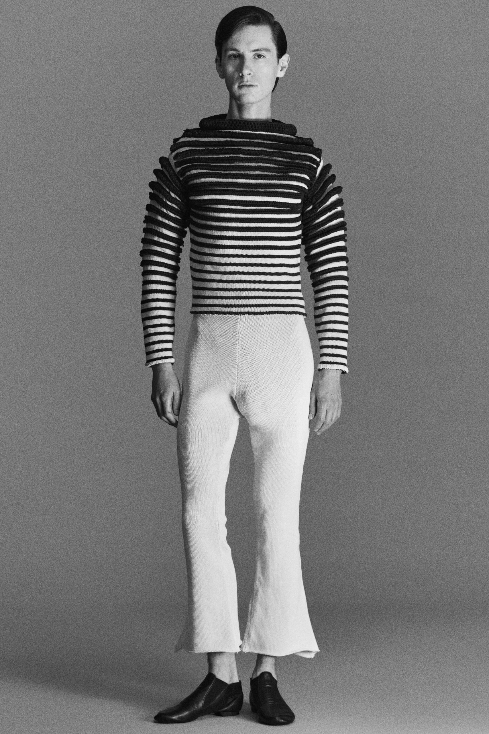 black and white striped top with flared pants