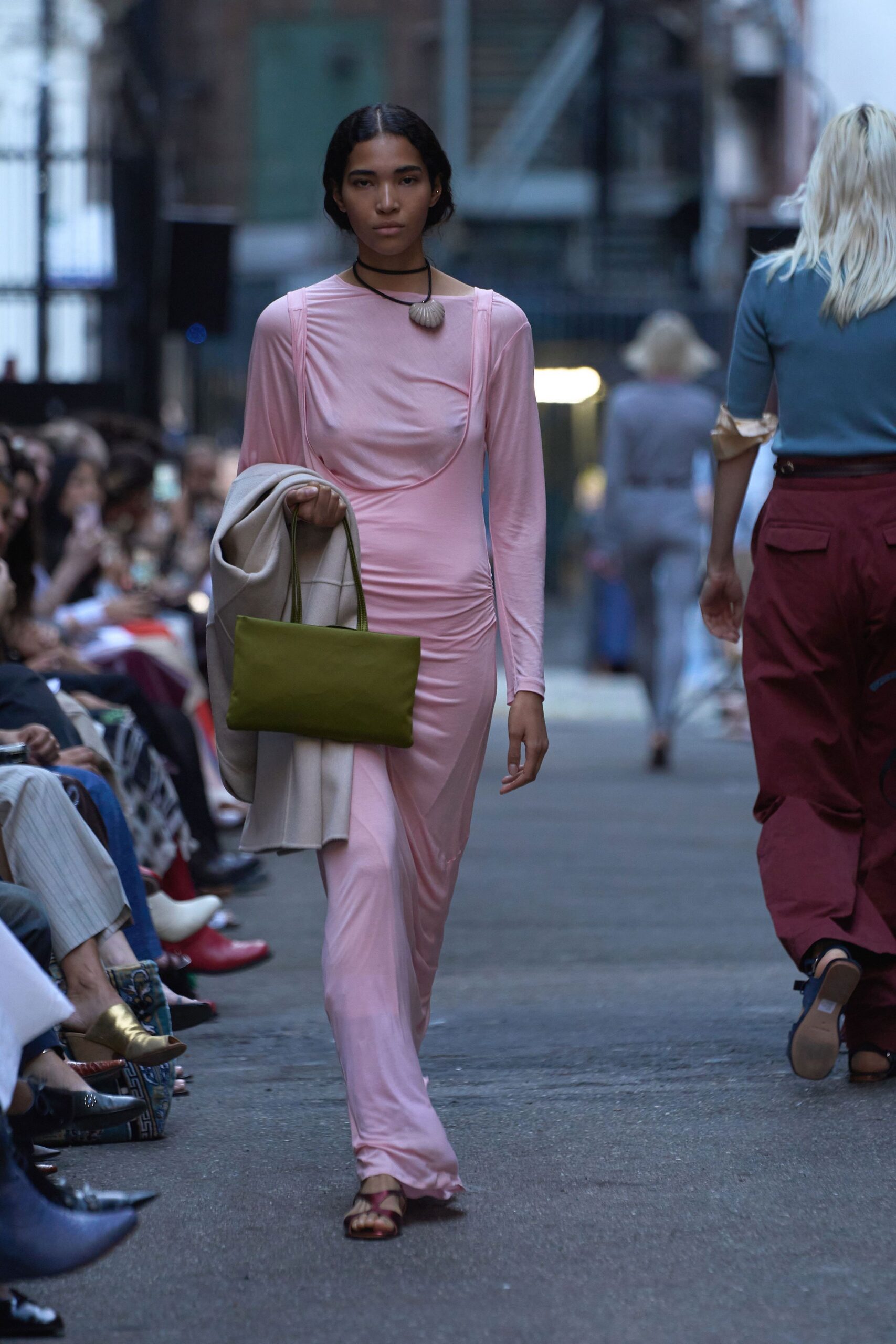 pink silk fitted dress with green bag