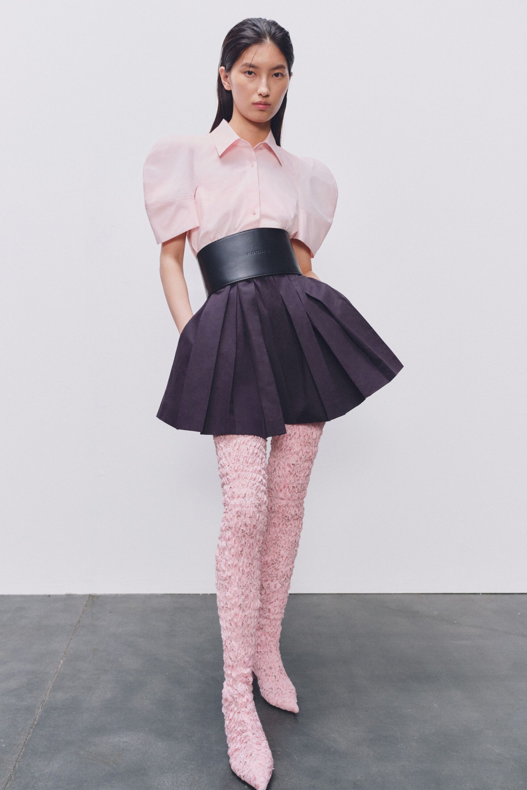 pink shirt black pleated skirt