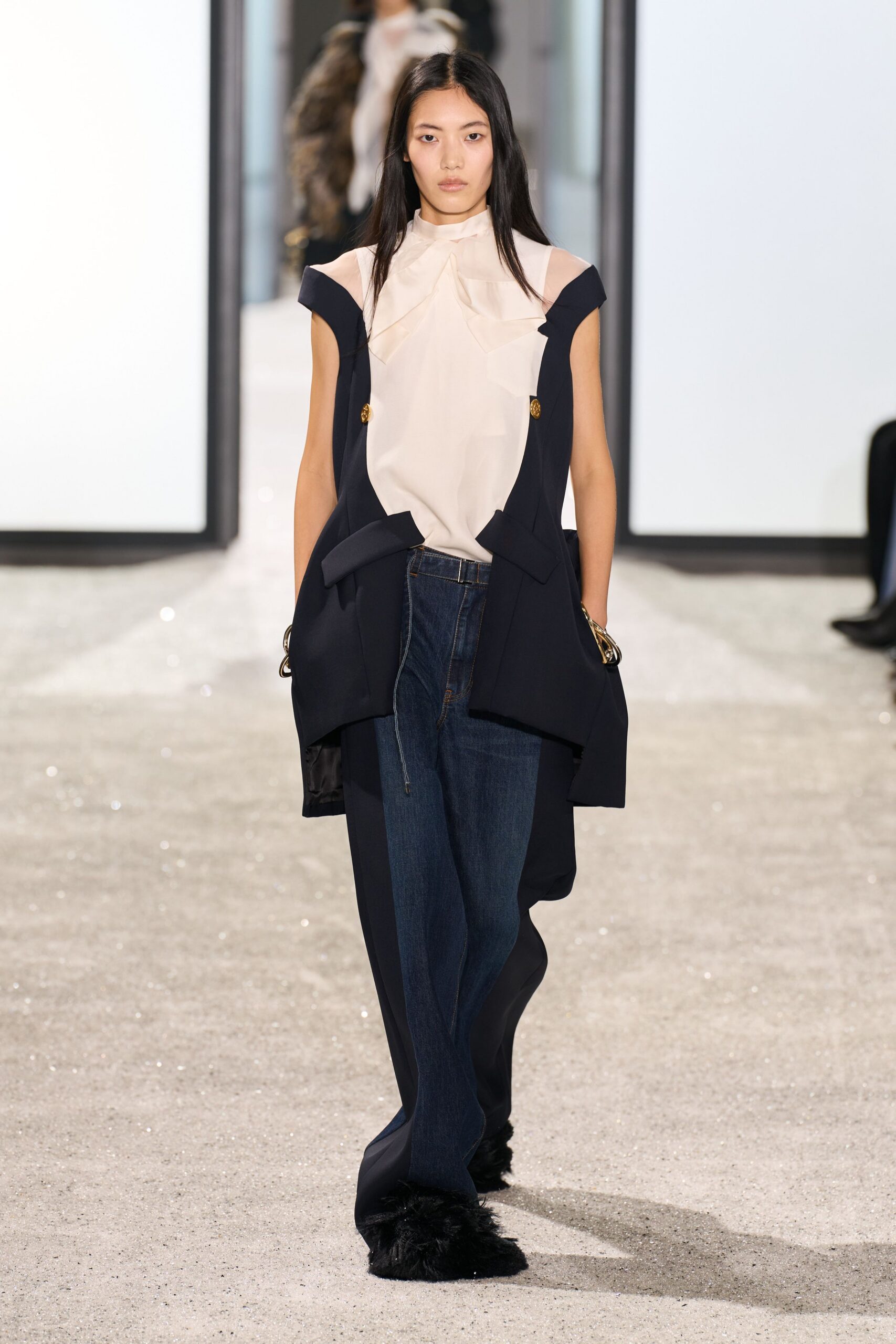 white silk blouse black jacket blue pants