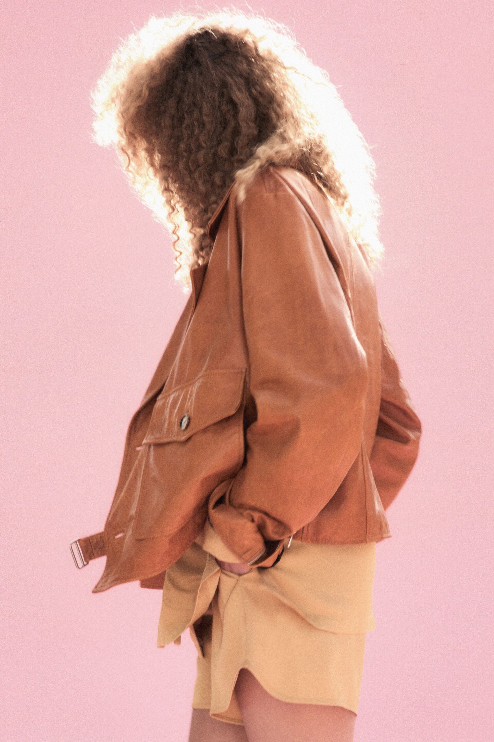 brown leather oversized jacket and beige skirt