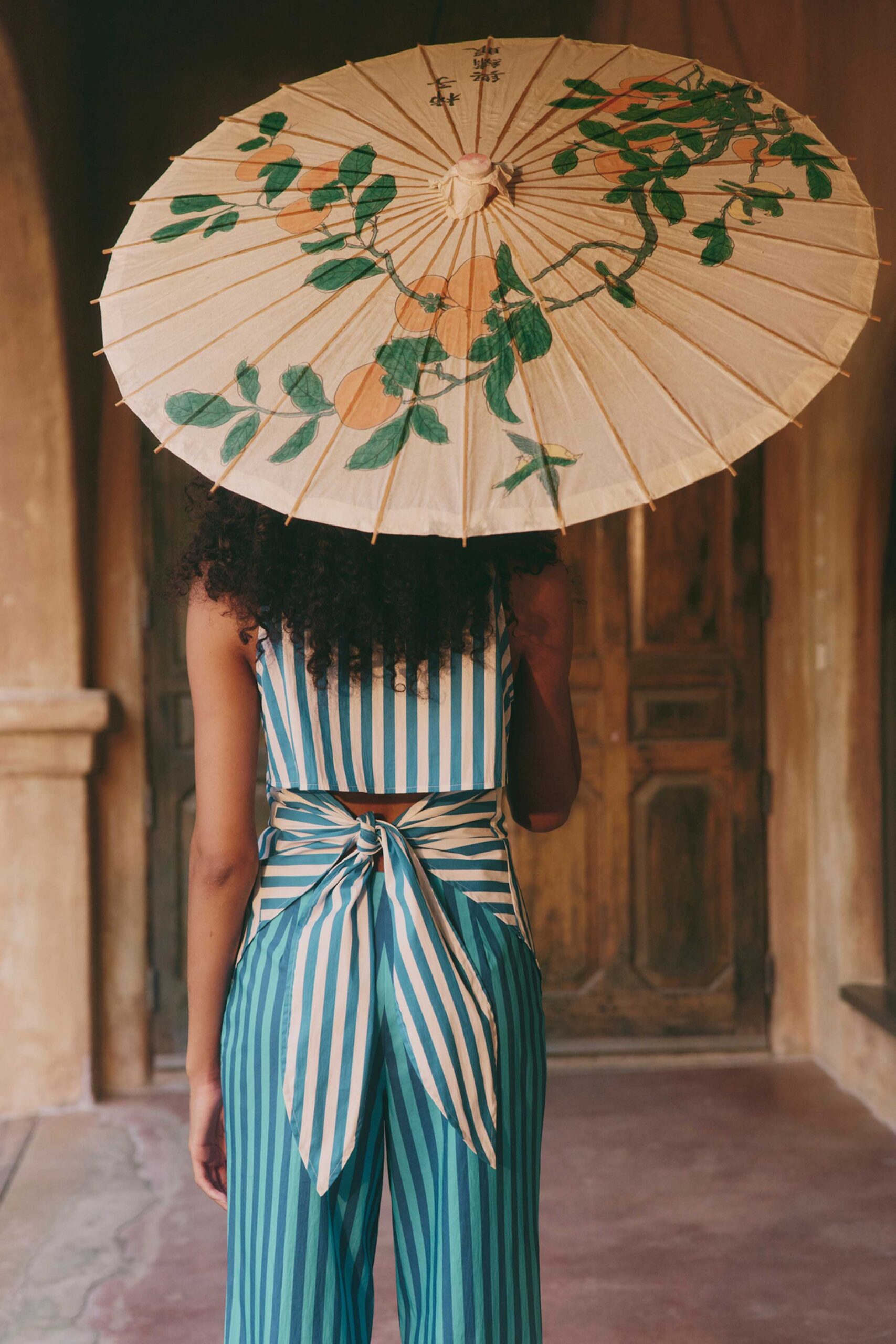 blue and white striped jumpsuit with parasol