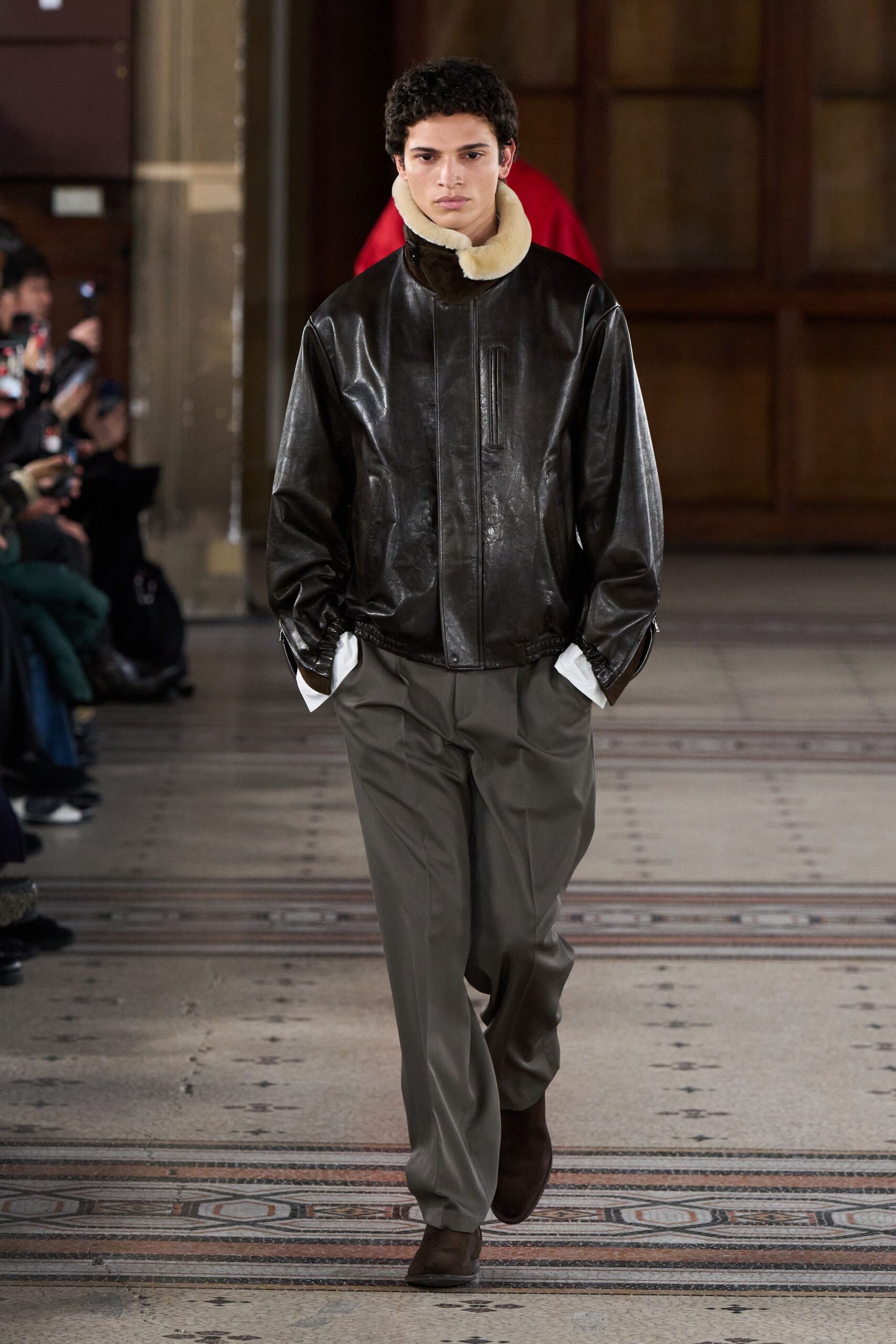 brown leather jacket with gray pants