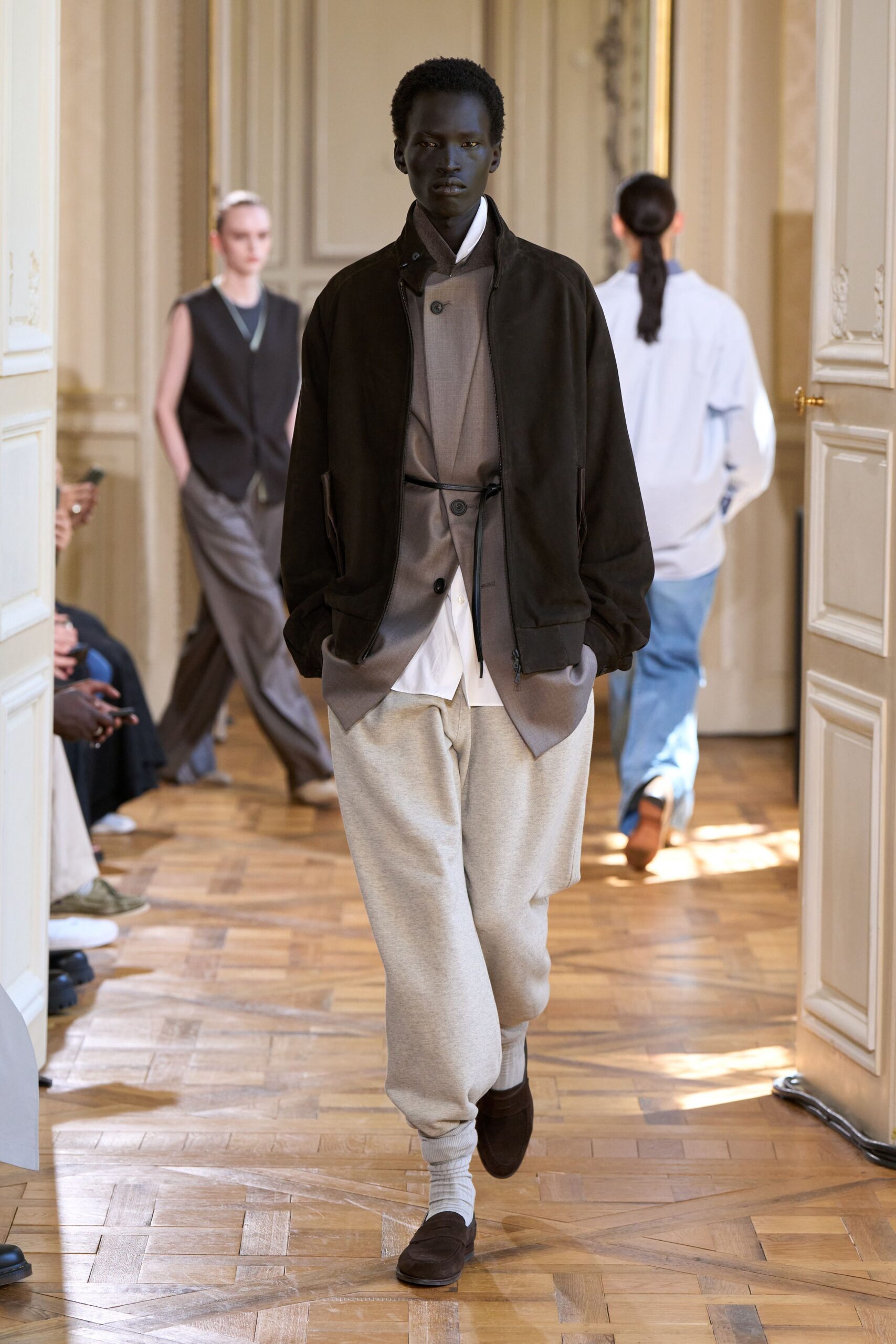 black jacket gray shirt beige pants
