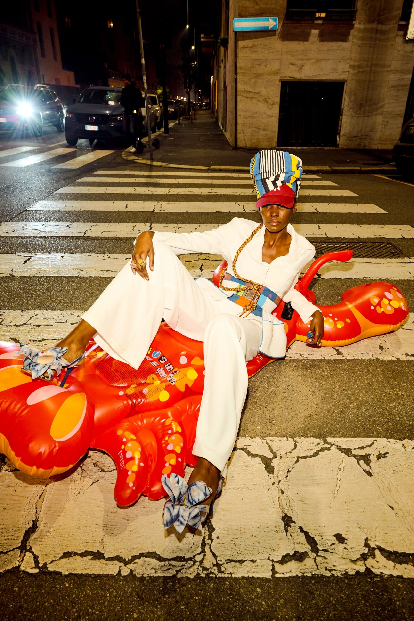white fitted jumpsuit with multi hat