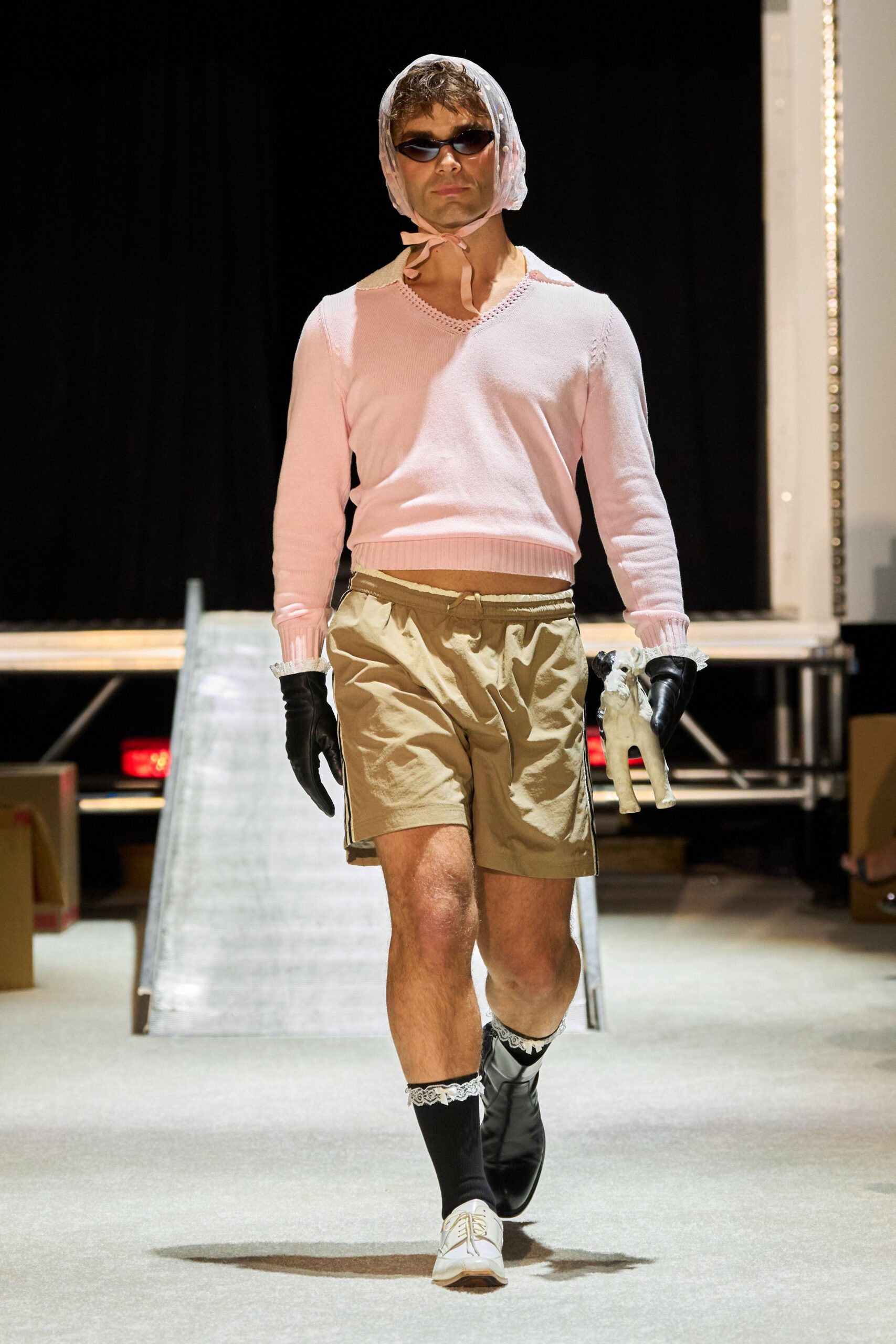 pink fitted sweater and beige shorts