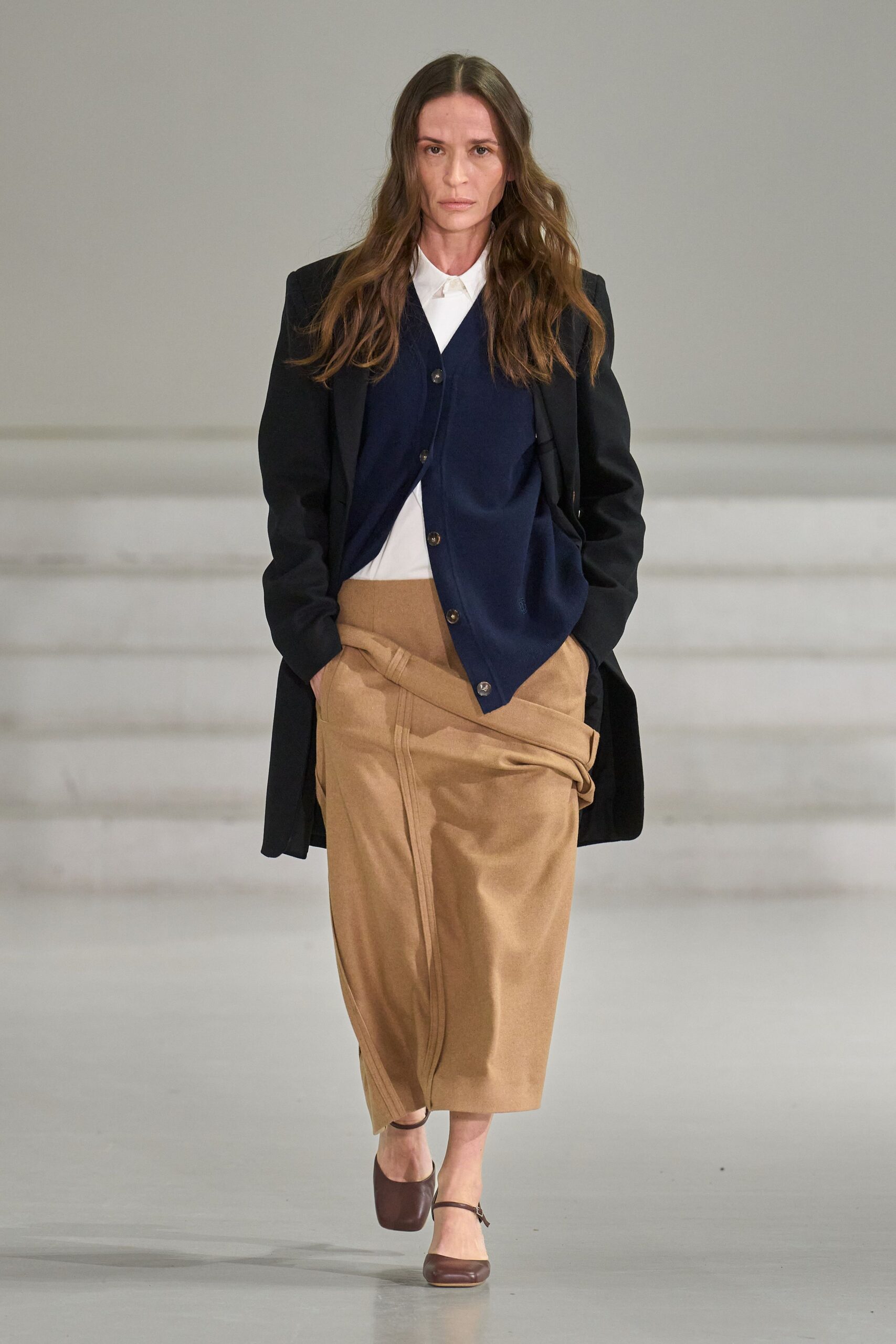 black coat navy vest white shirt beige skirt
