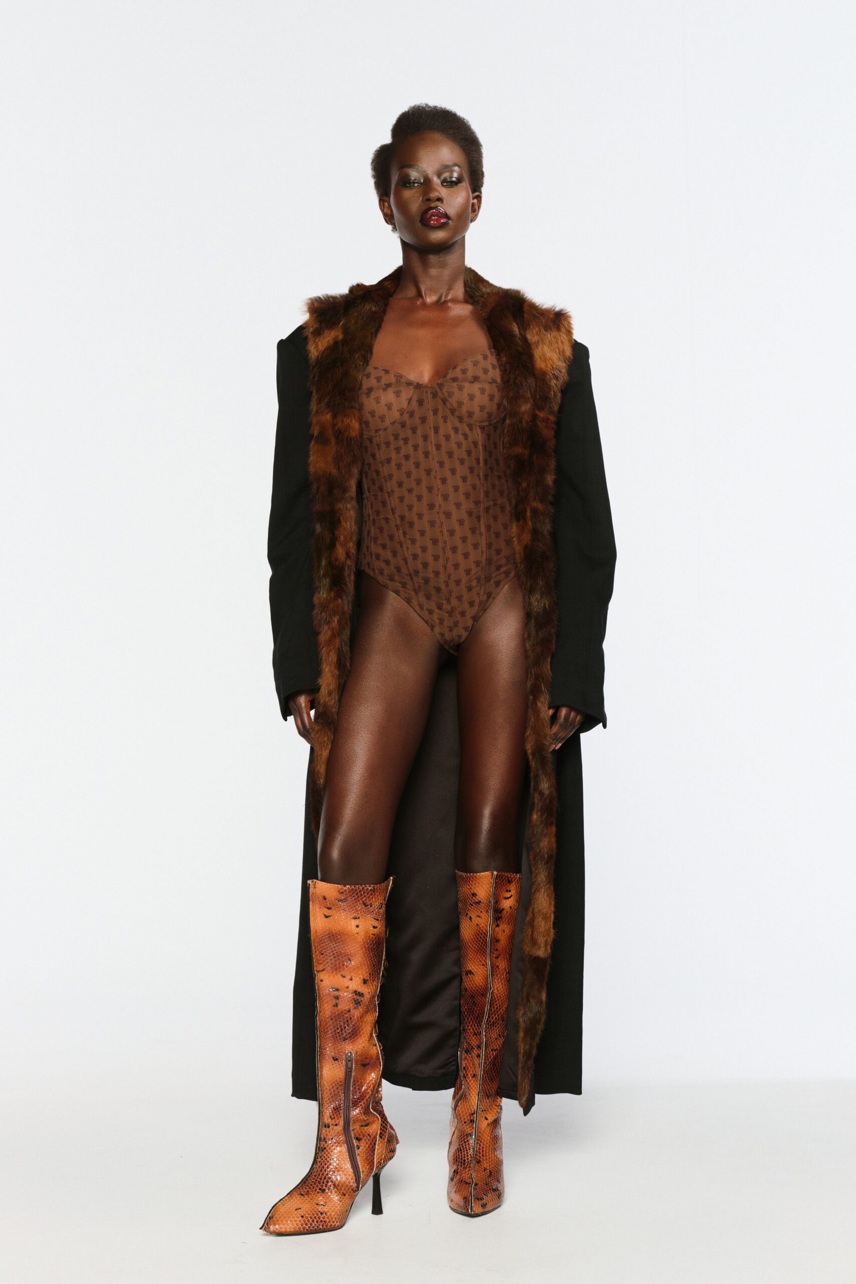 black faux-fur coat with brown bodysuit and boots