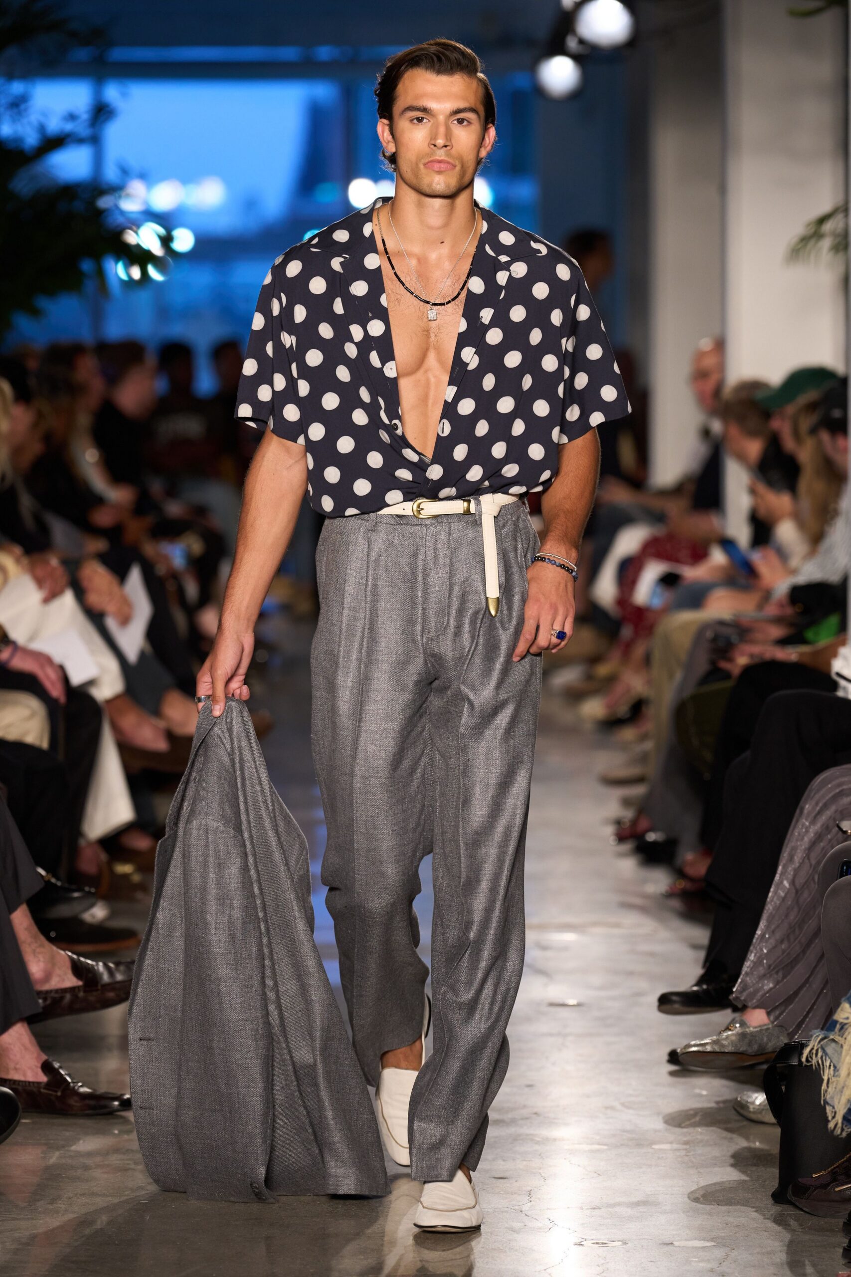 navy polka-dot shirt with gray pants