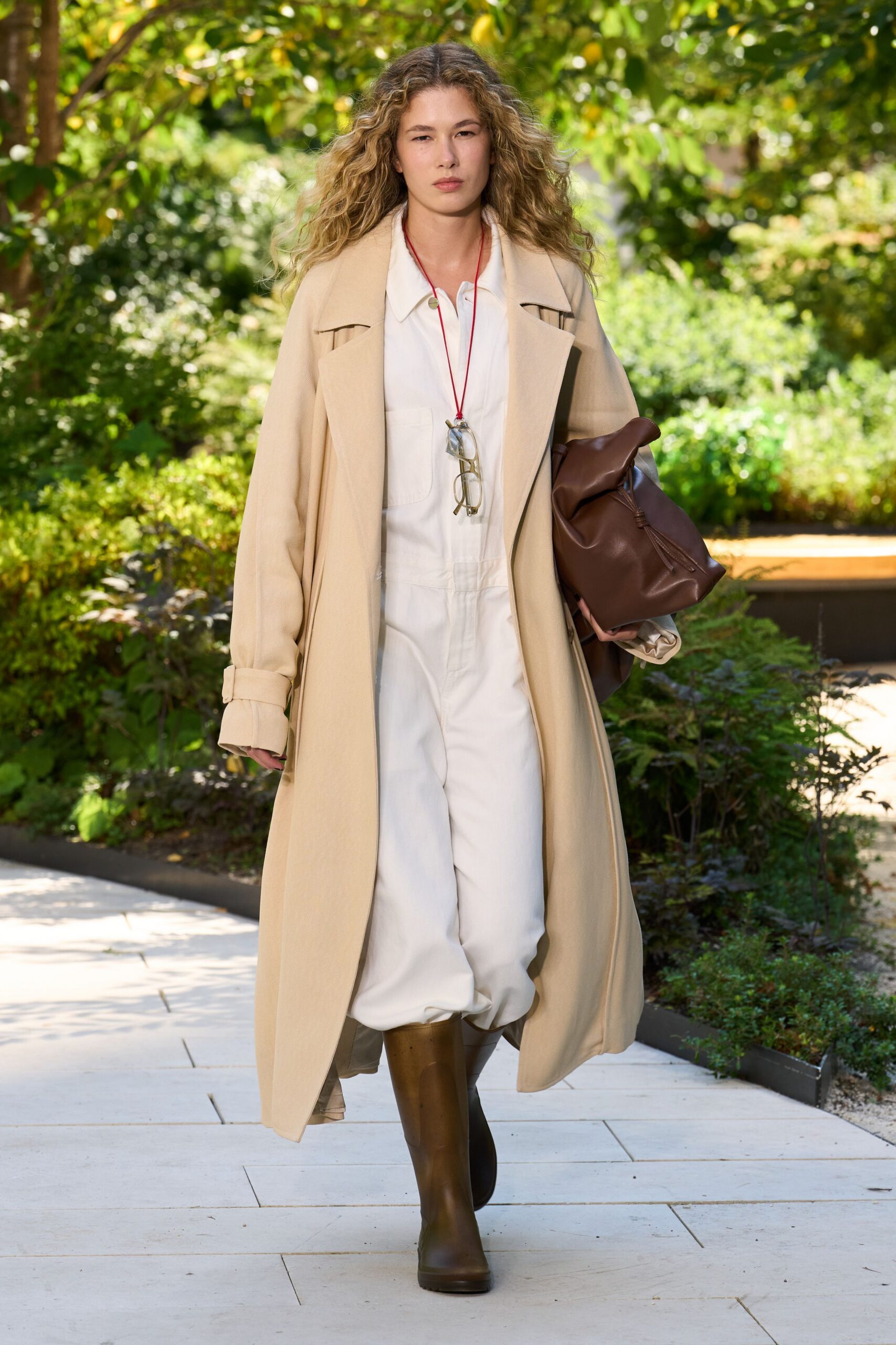 beige coat white jumpsuit brown boots