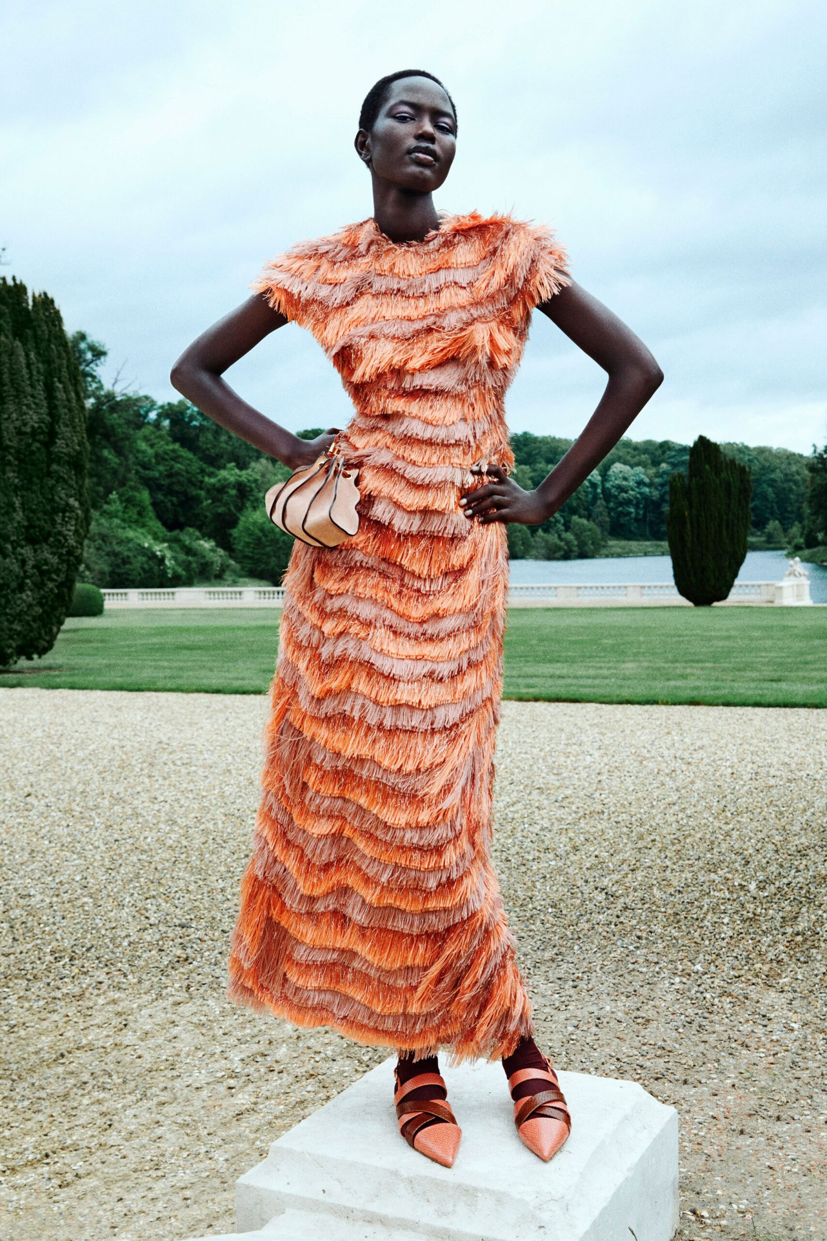 orange fringed gown with shoes and bag