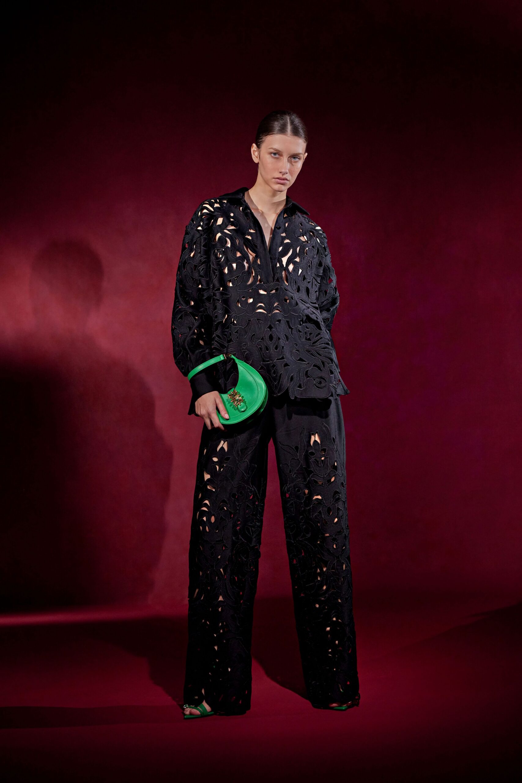 black embroidered shirt and pants with green bag