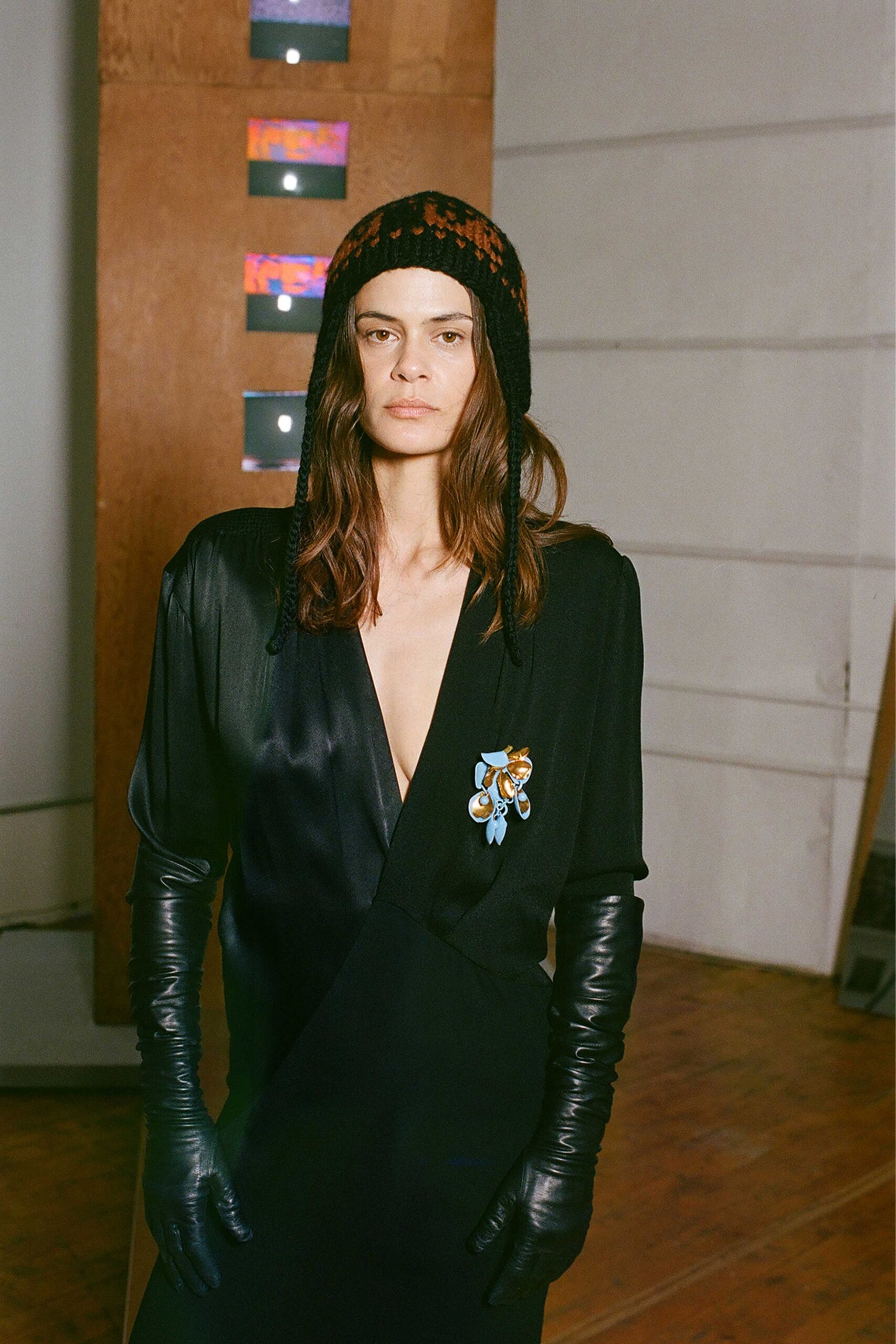 black fitted midi dress with gloves and hat