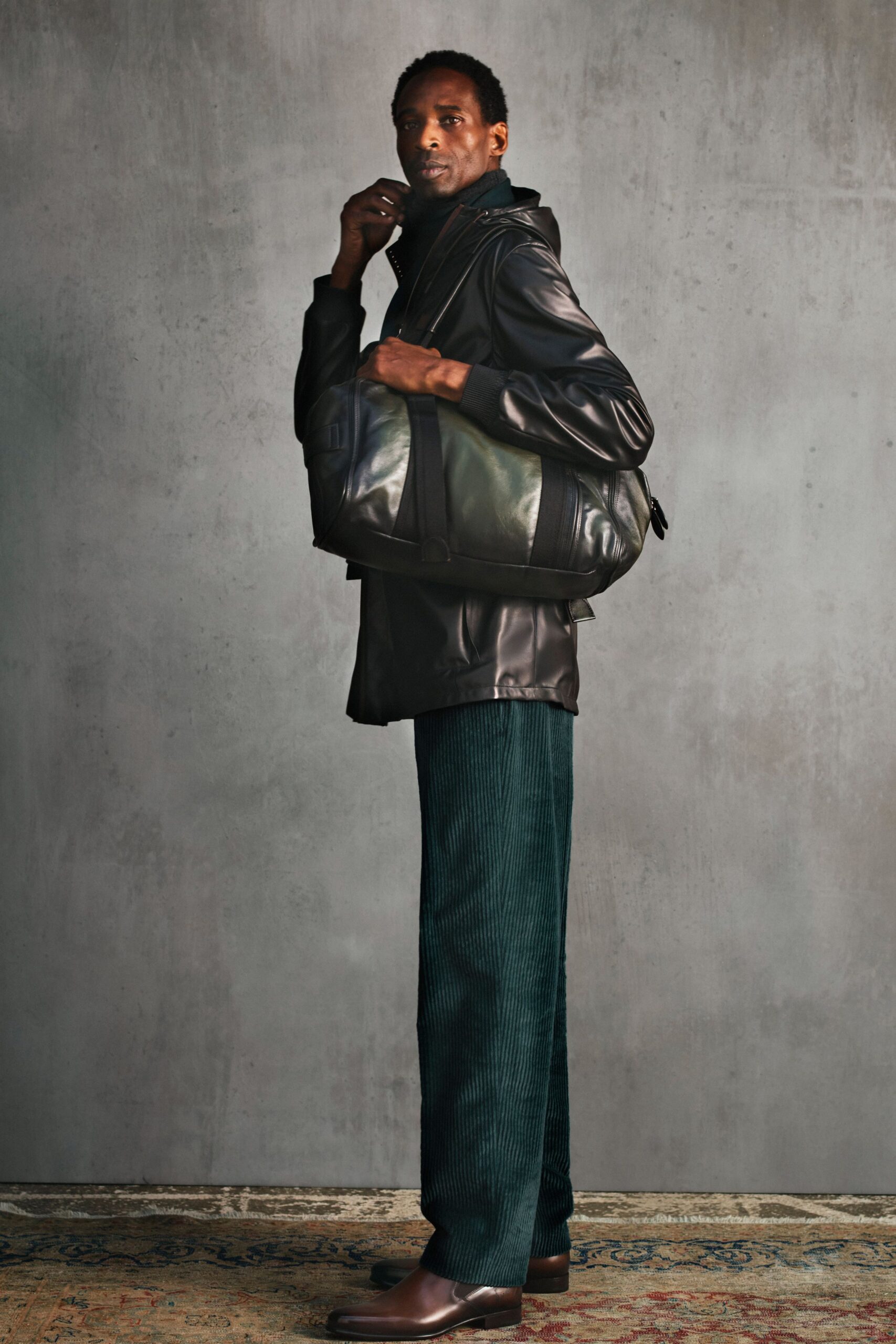 black leather jacket with green pants