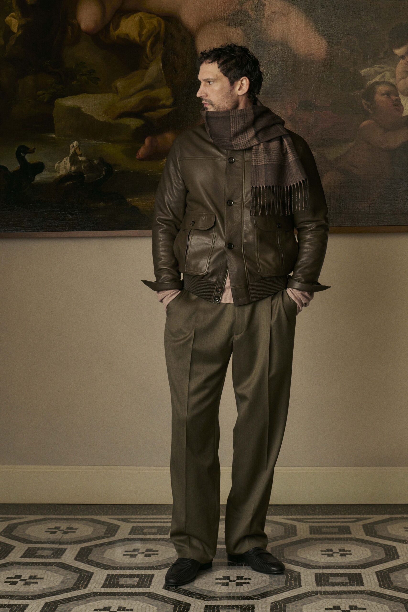 brown leather jacket with gray pants