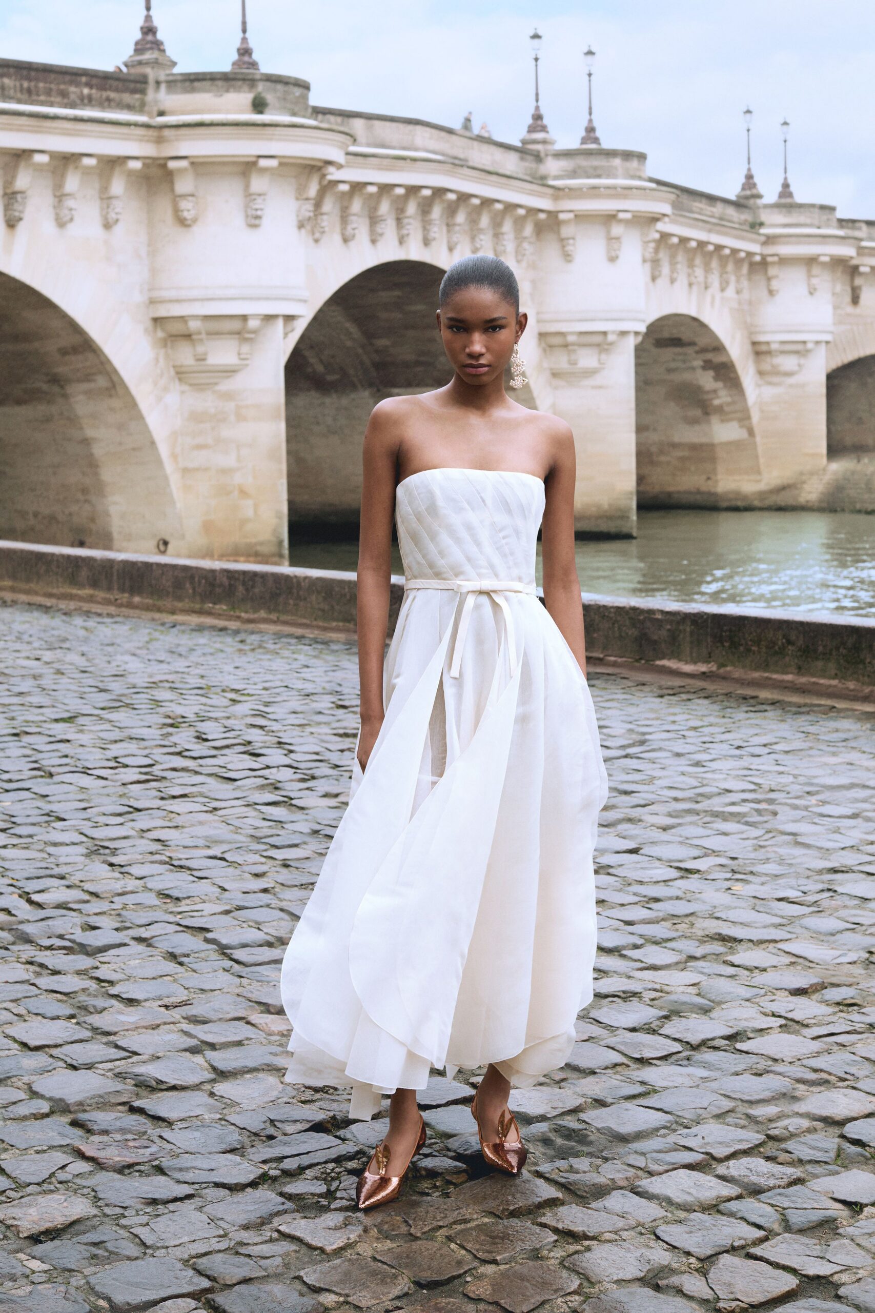white cotton strapless fitted tiered belted flowing gown