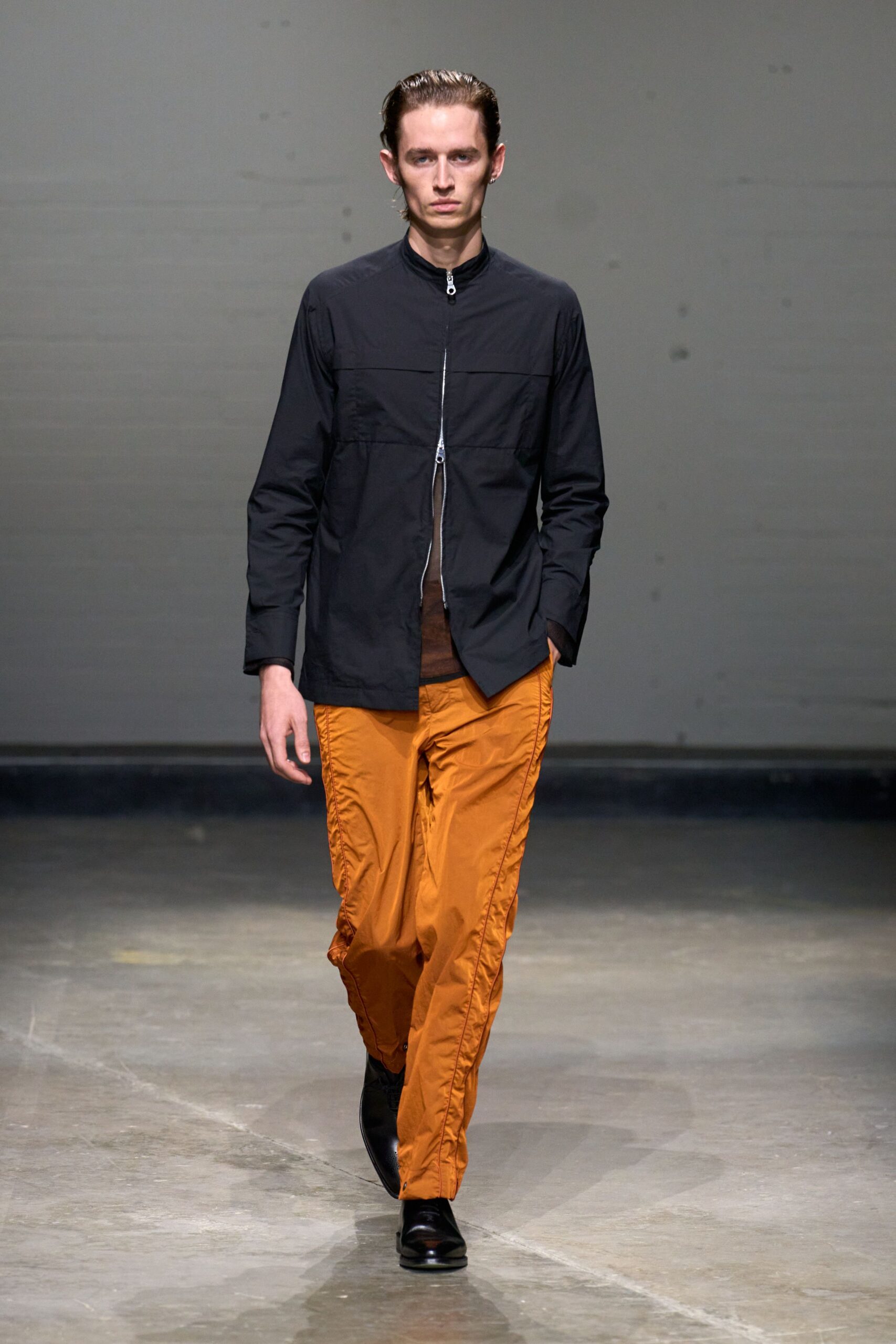 black jacket orange pants