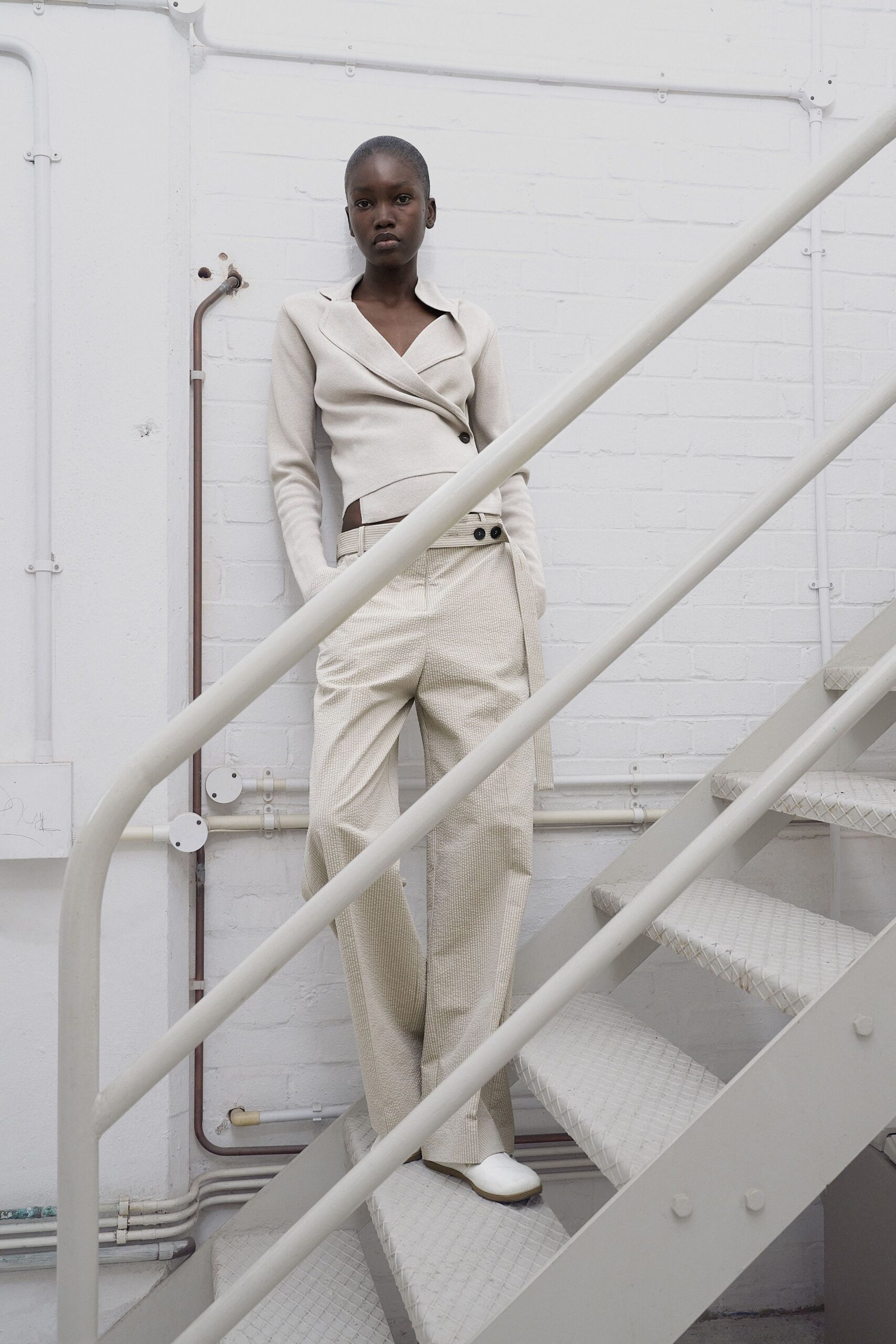 white fitted top beige relaxed pants