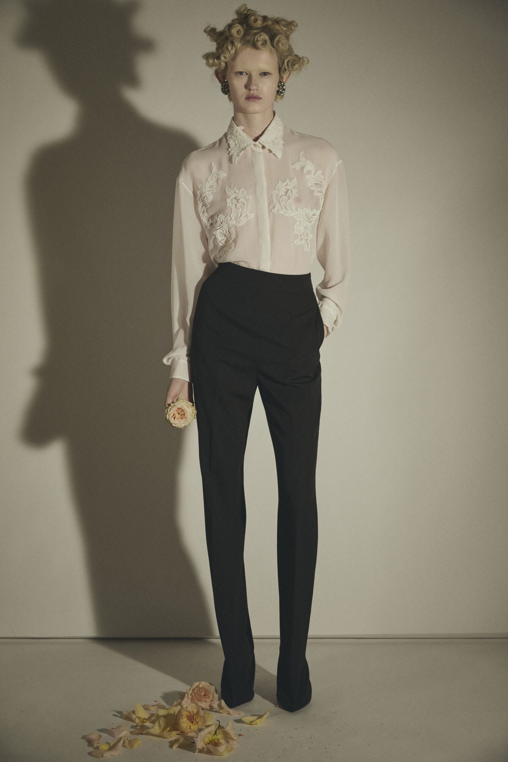 pink silk embroidered shirt and black tailored pants