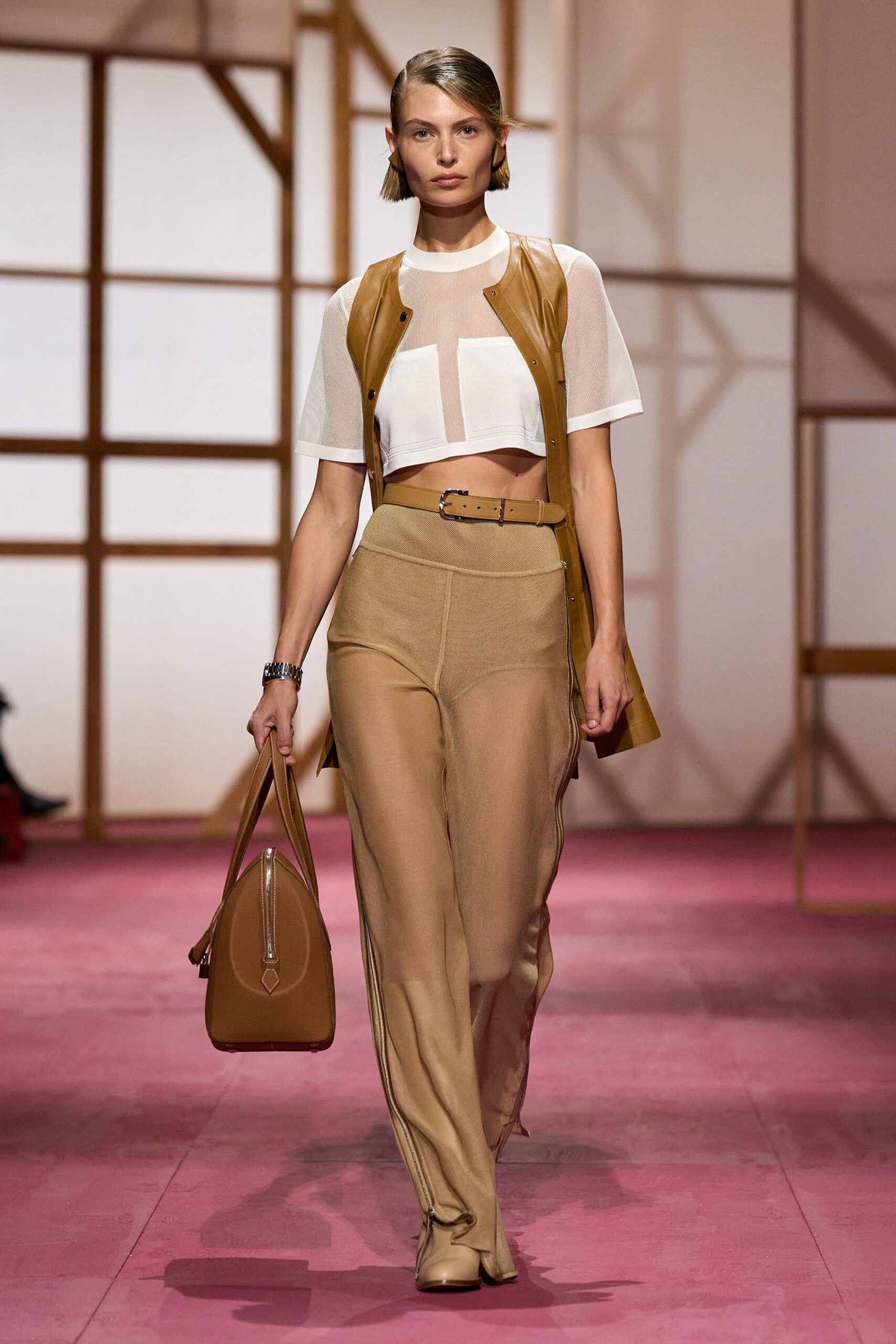 white fitted top brown leather vest beige tailored pants