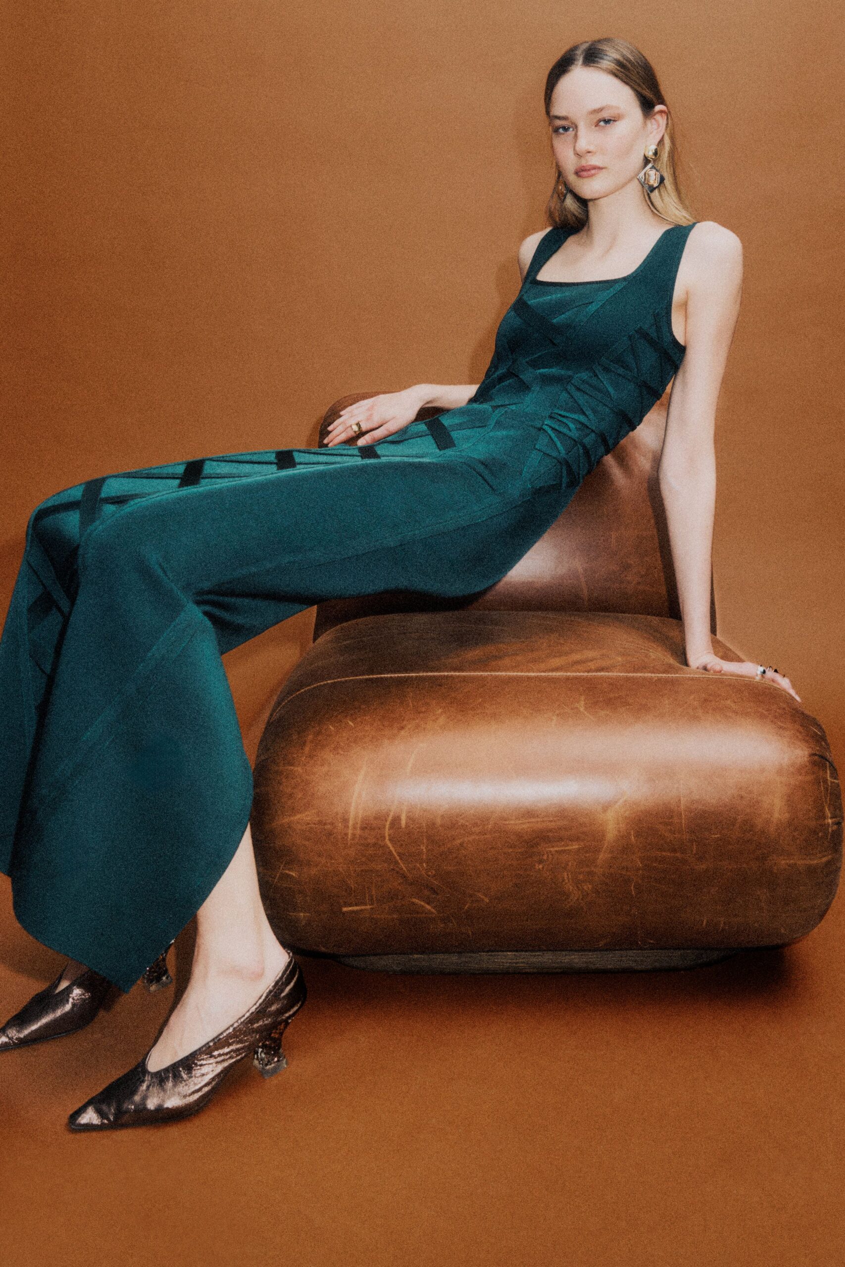 green fitted sleeveless jumpsuit with brown shoes