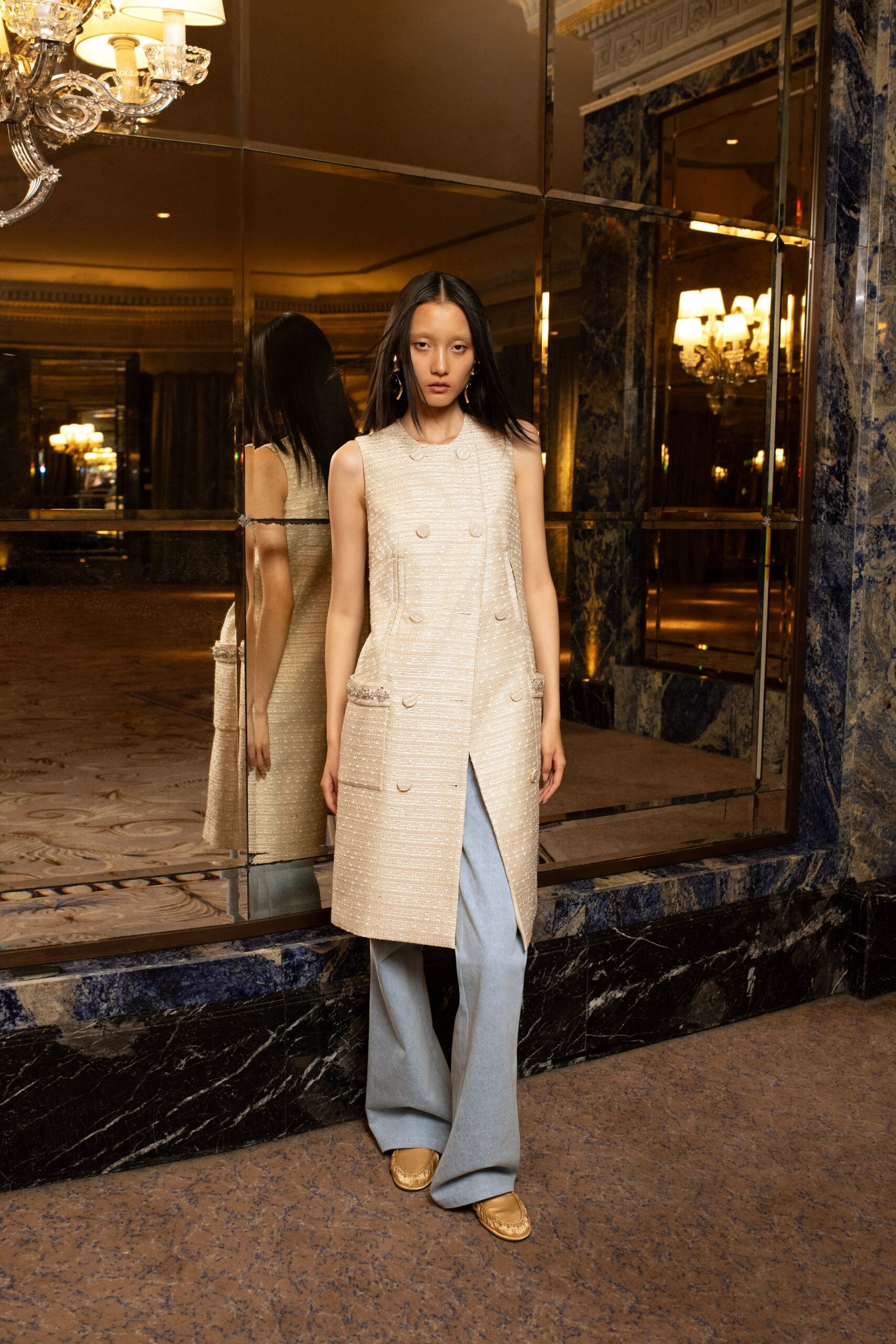 beige tailored vest with blue pants