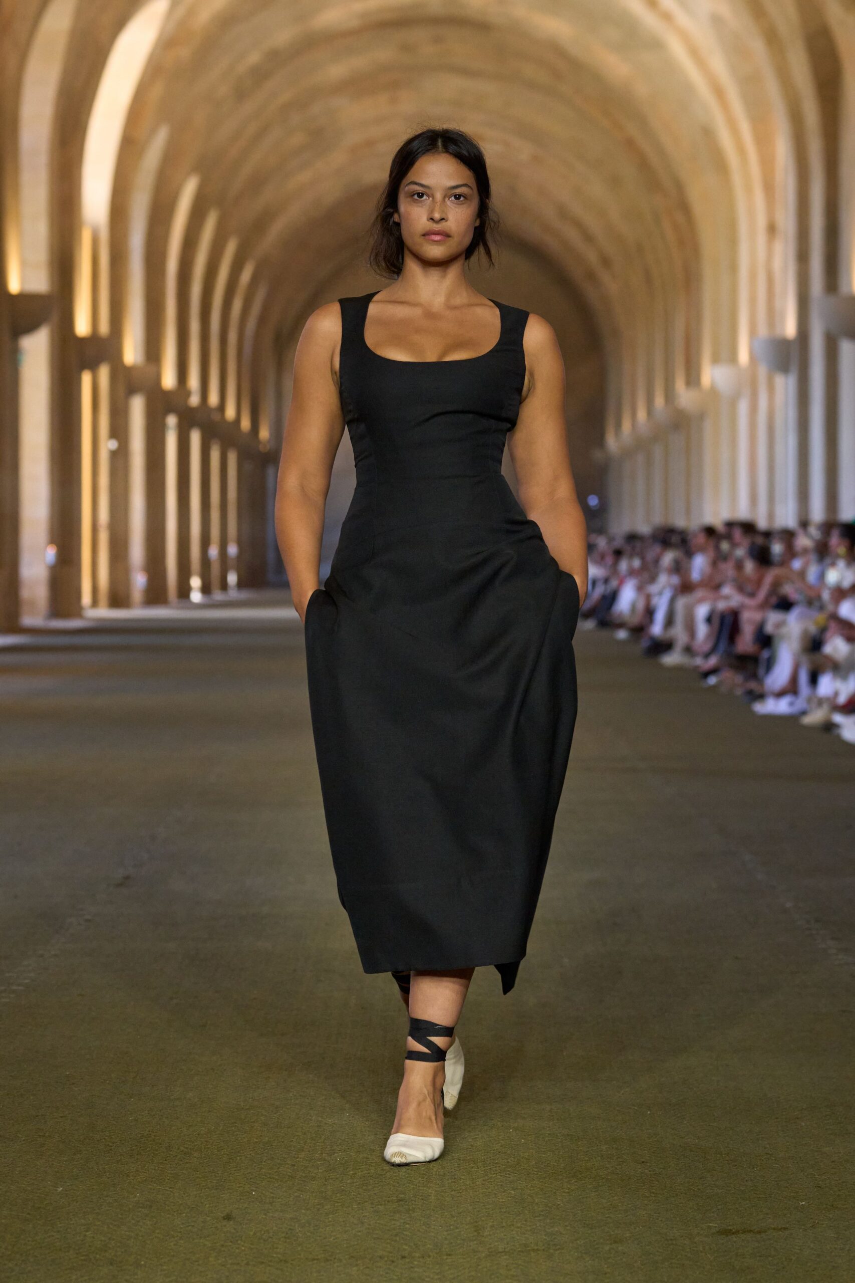 black fitted midi dress and white shoes