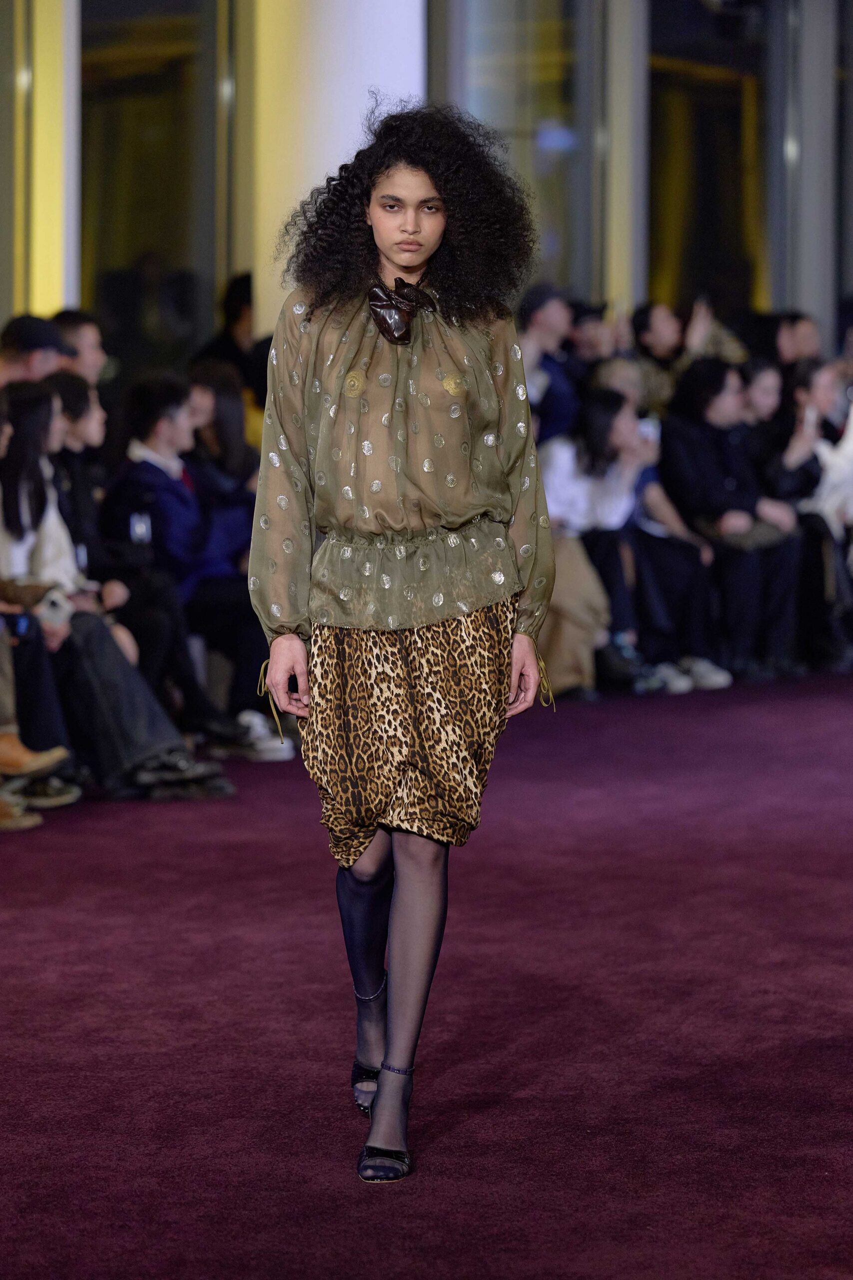 green embroidered blouse with animal-print skirt