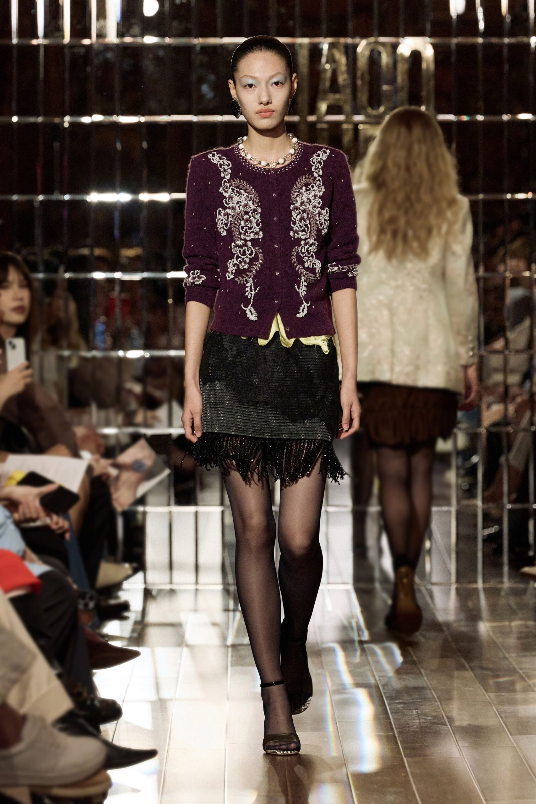 purple embroidered cardigan and black mini skirt