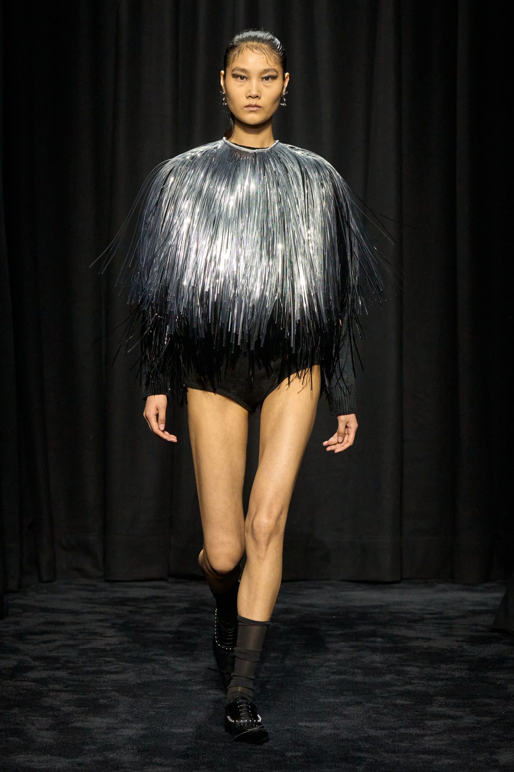 black bodysuit with silver fringed cape