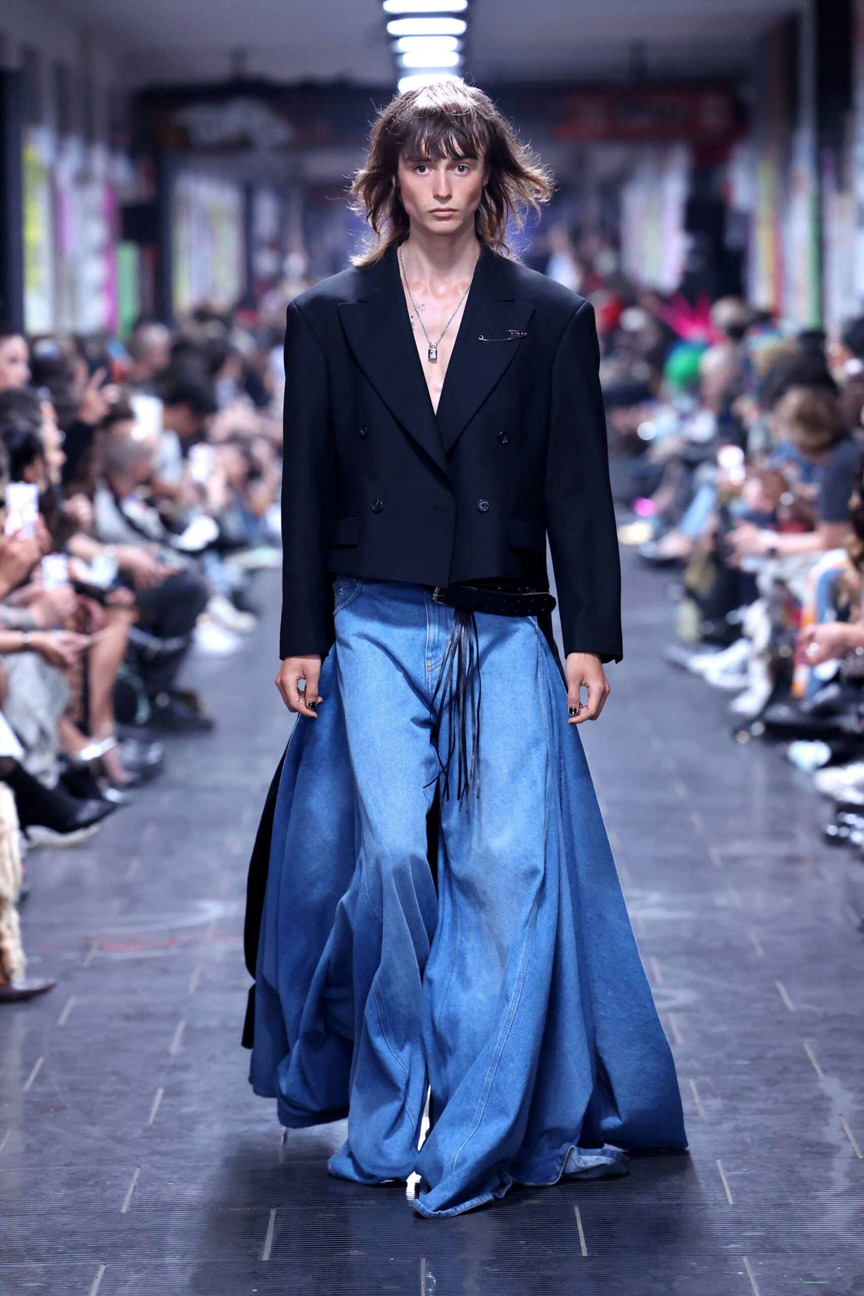 black tailored blazer and blue denim pants