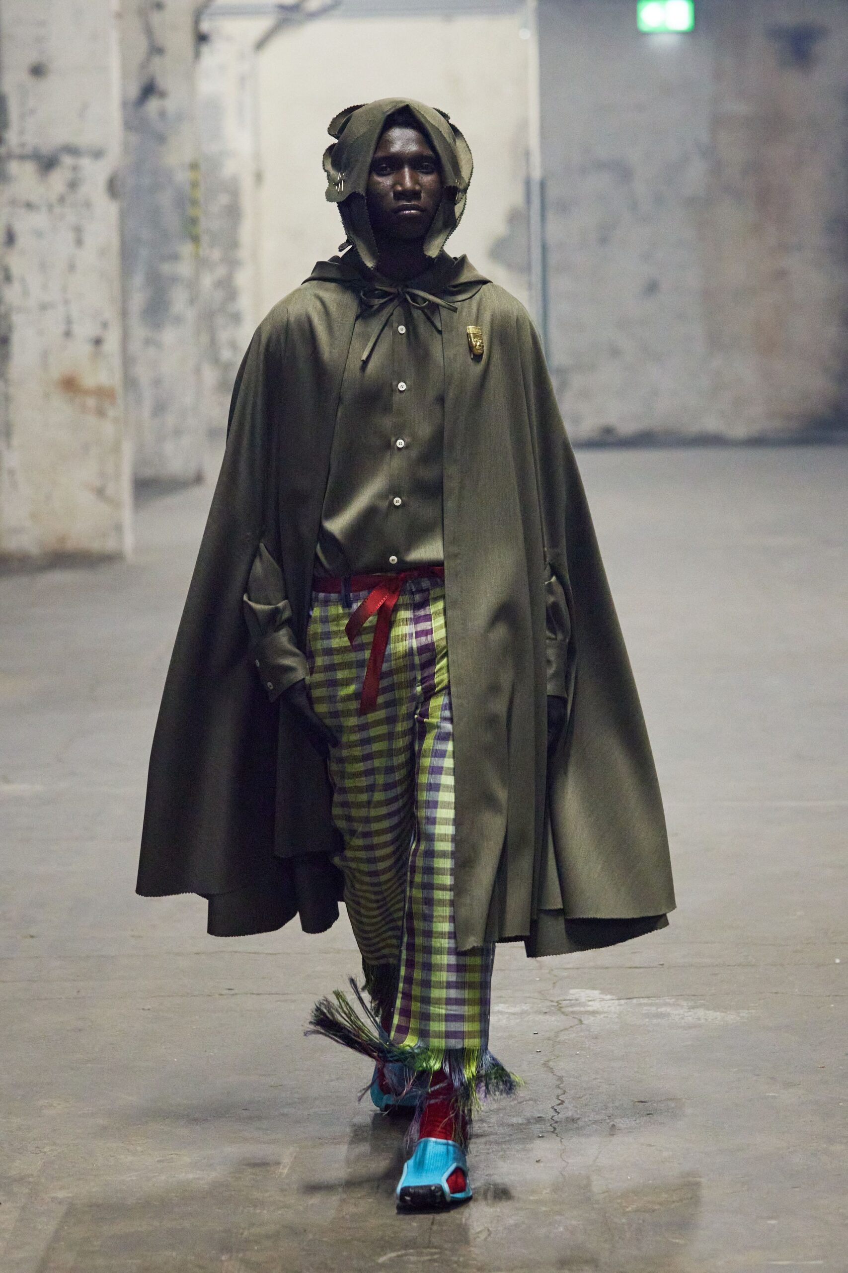green cape with checked pants