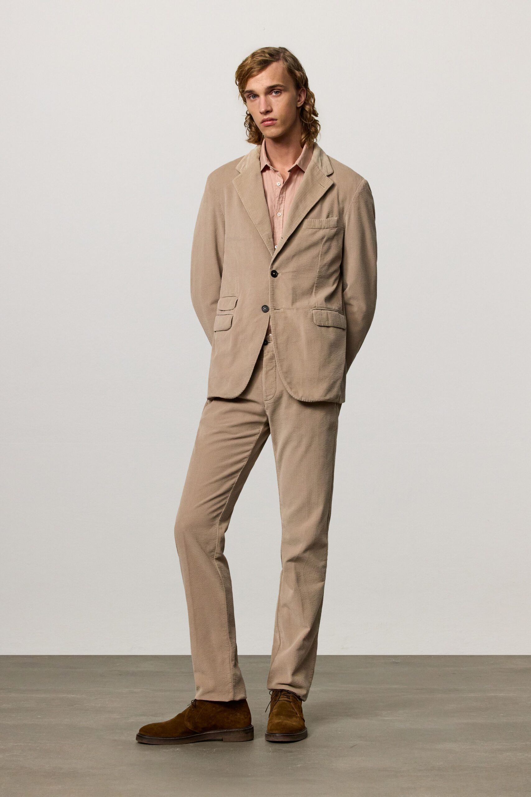 beige tailored suit with pink shirt