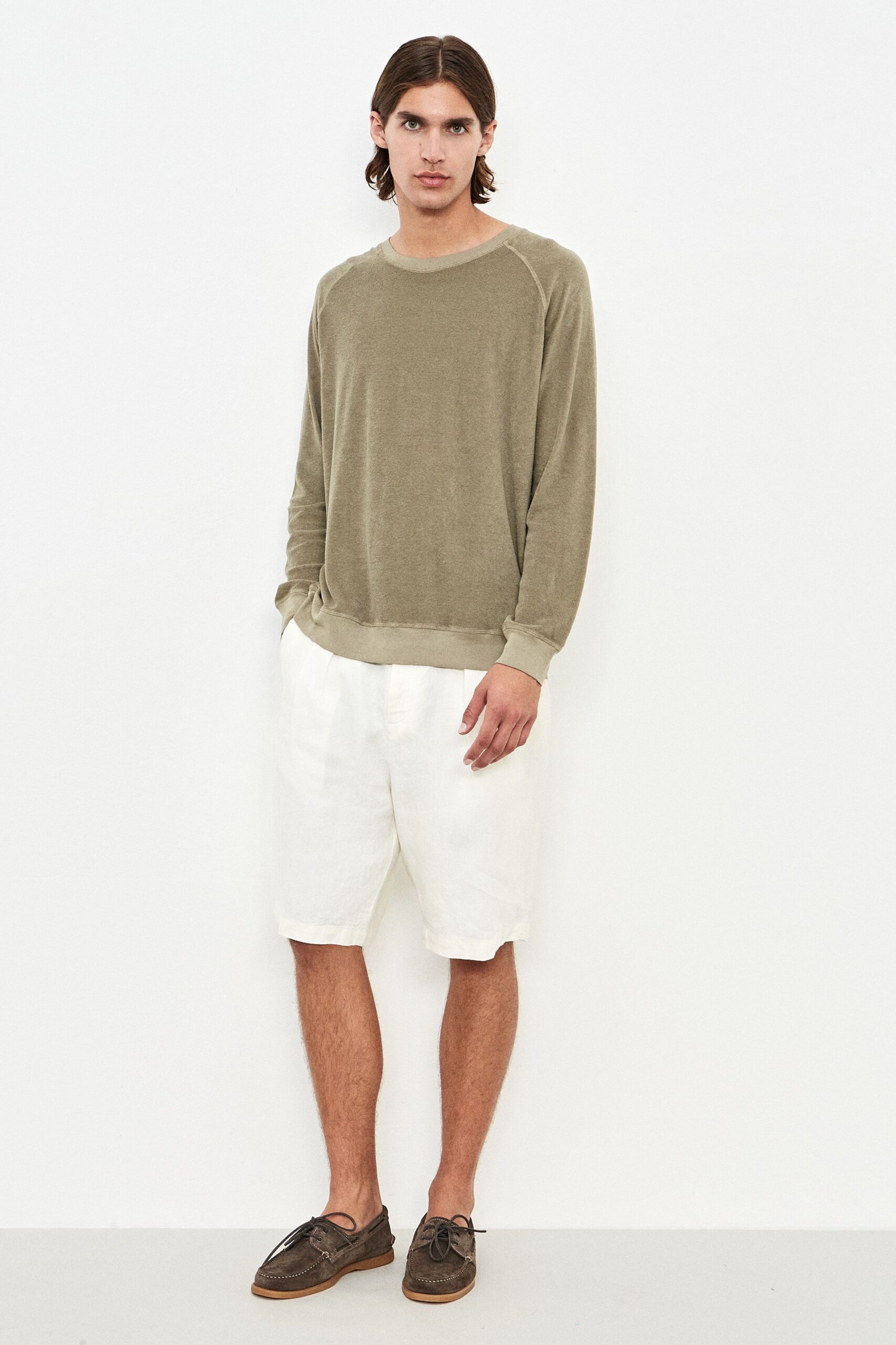 green relaxed sweater with white shorts