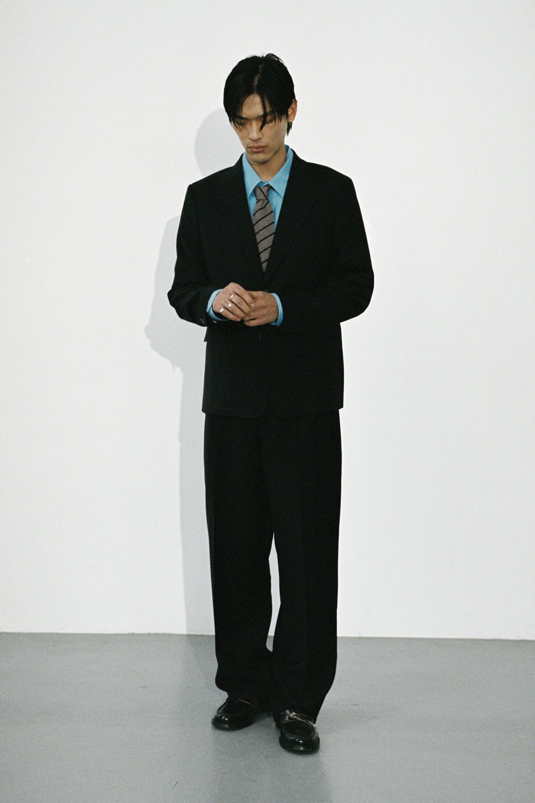 black tailored suit with blue shirt