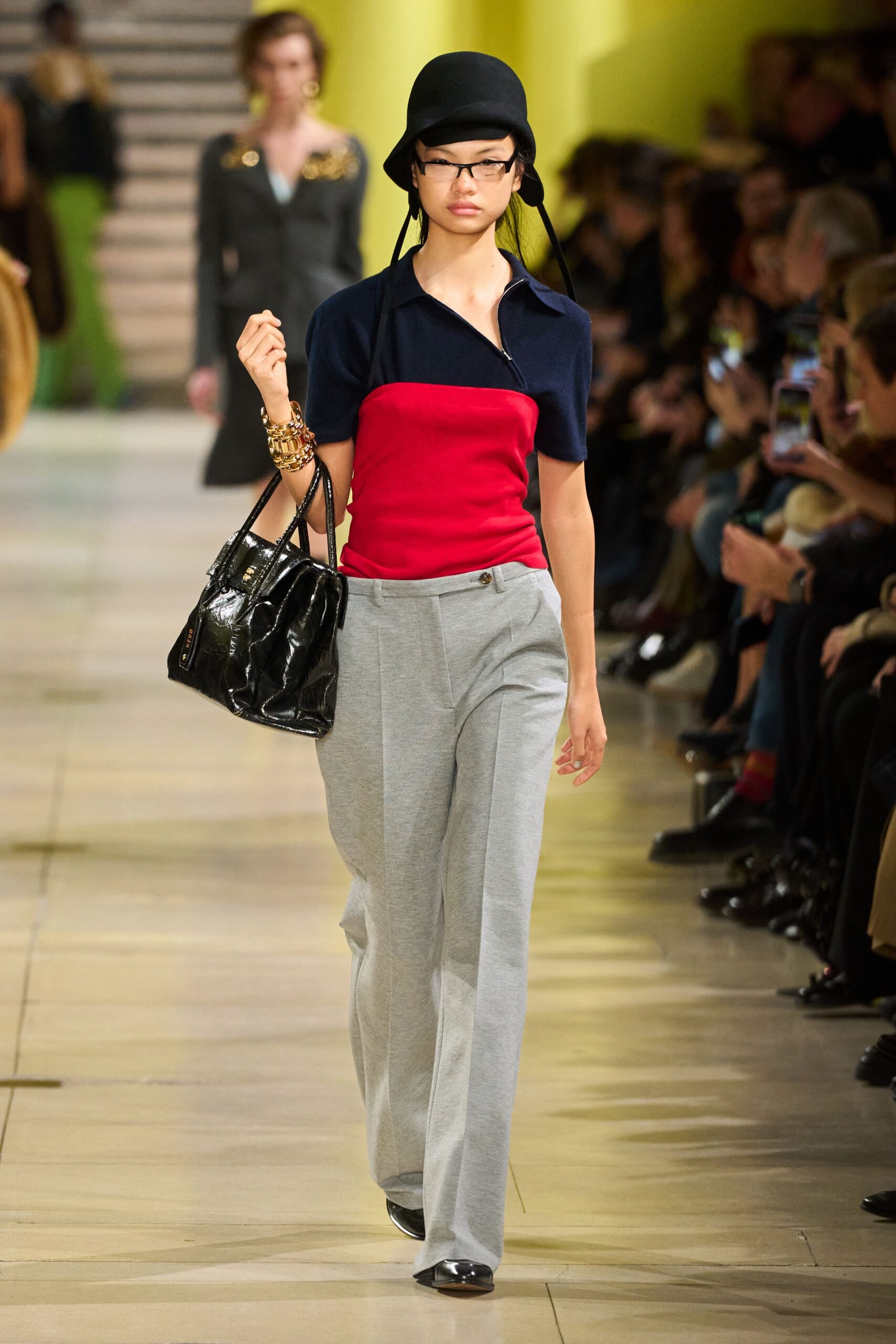 fitted red and blue top with gray pants