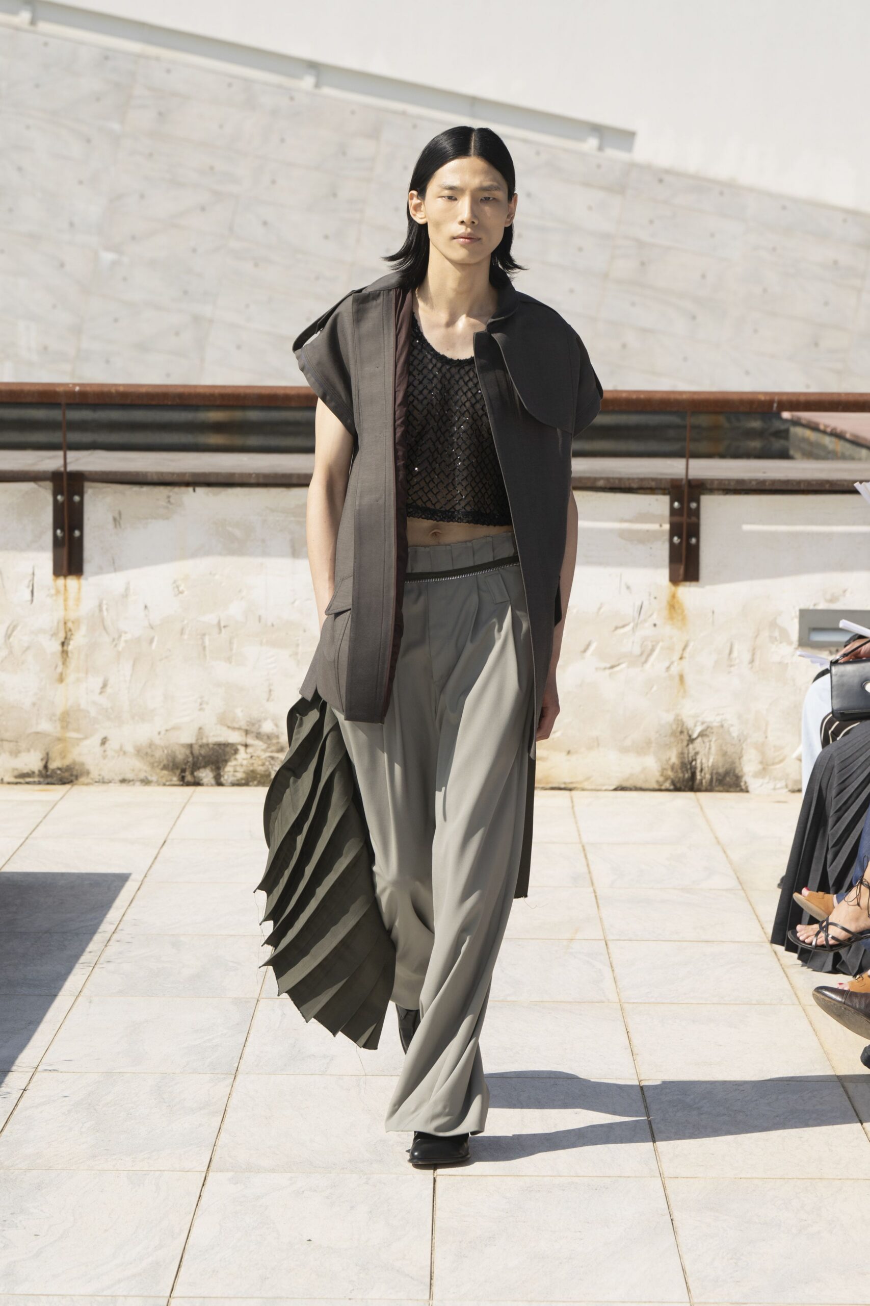 black relaxed jacket gray pleated pants