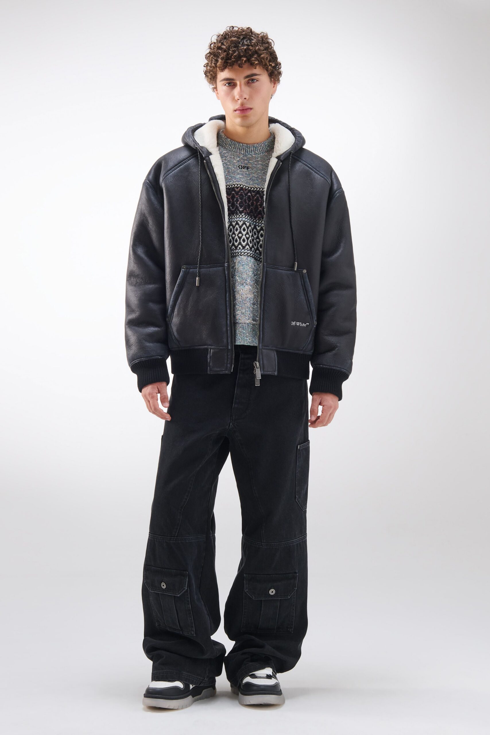 black leather jacket with sweater and cargo pants