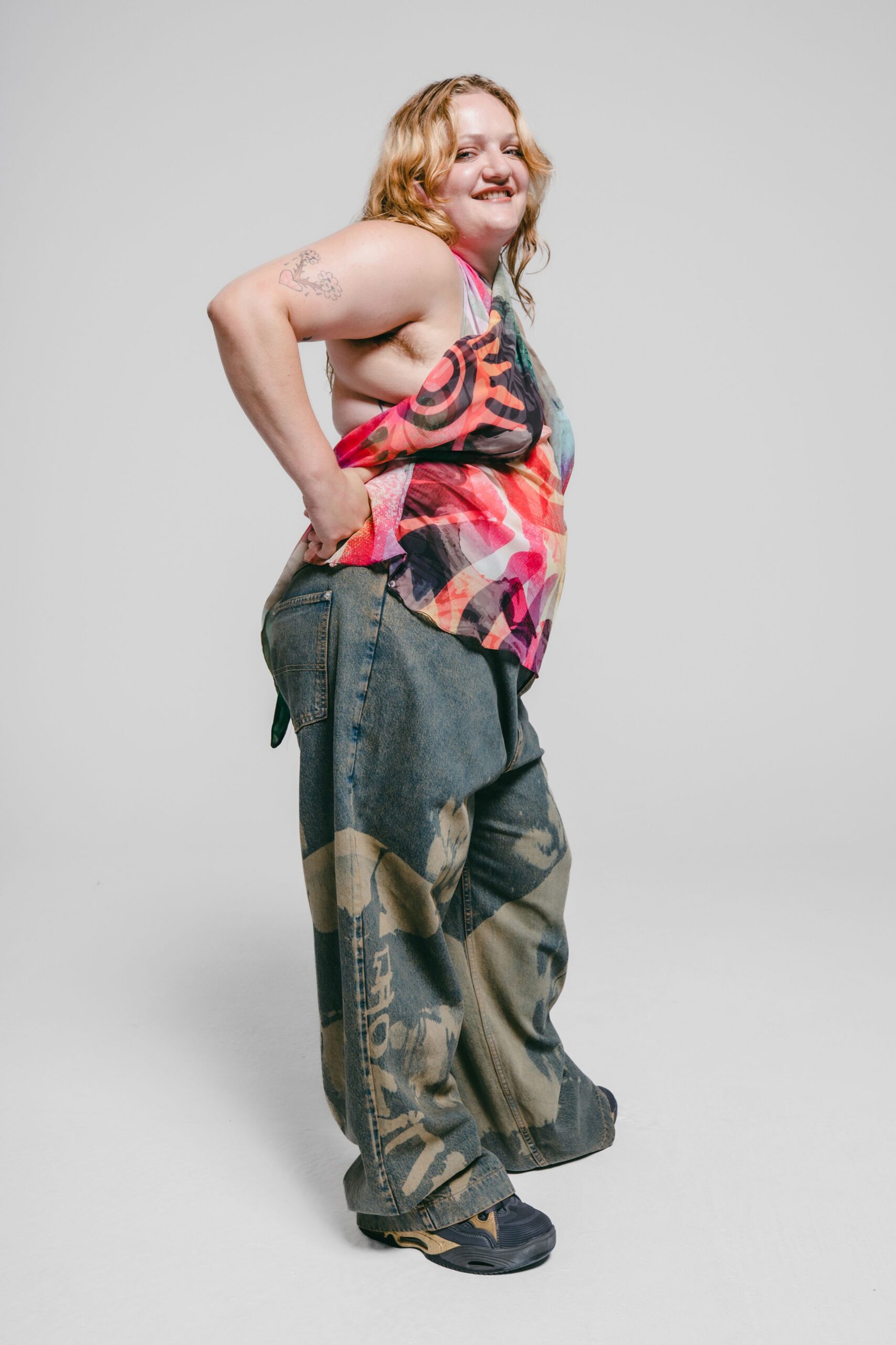multi-colored sleeveless top with distressed jeans