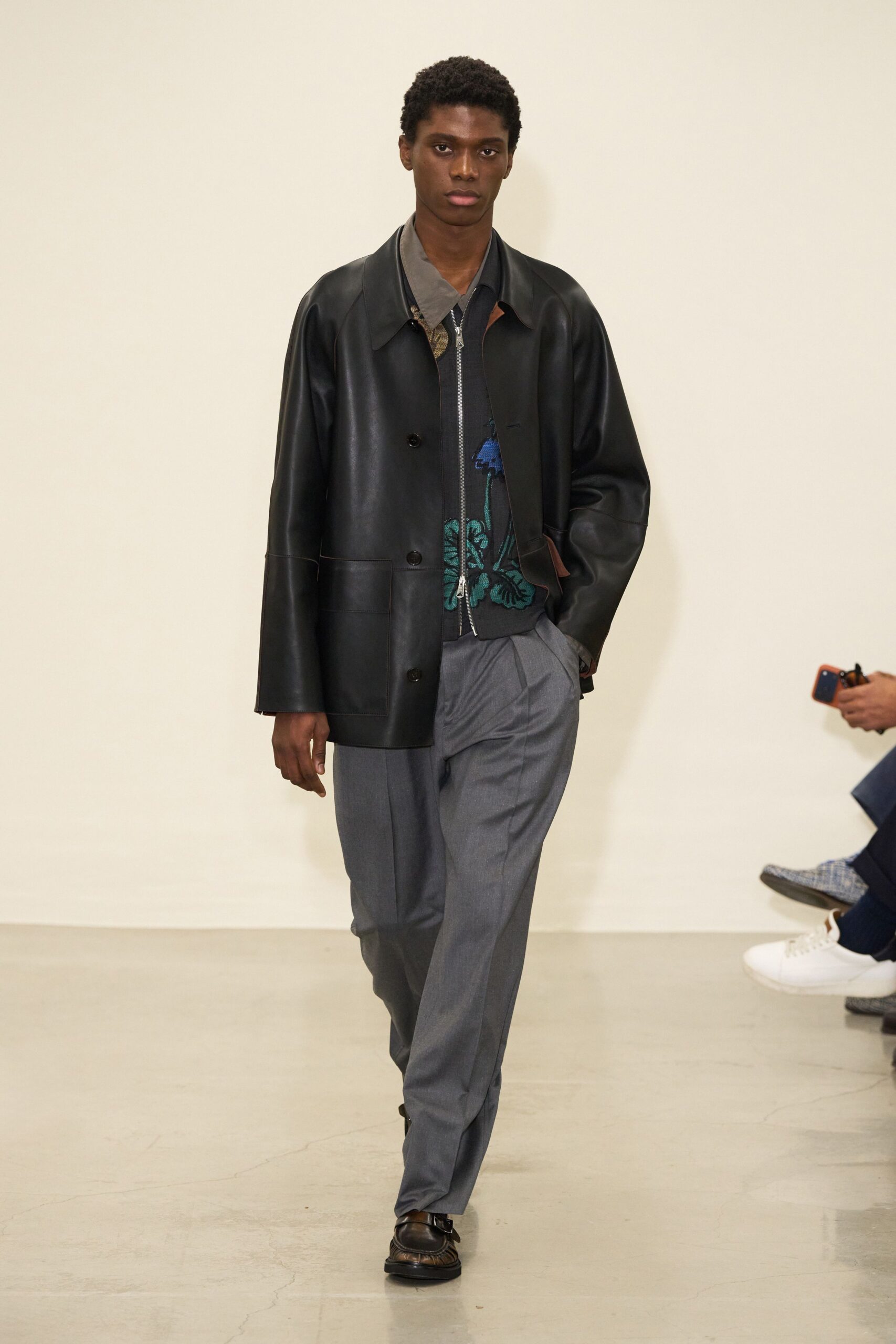 black leather jacket gray shirt tailored pants