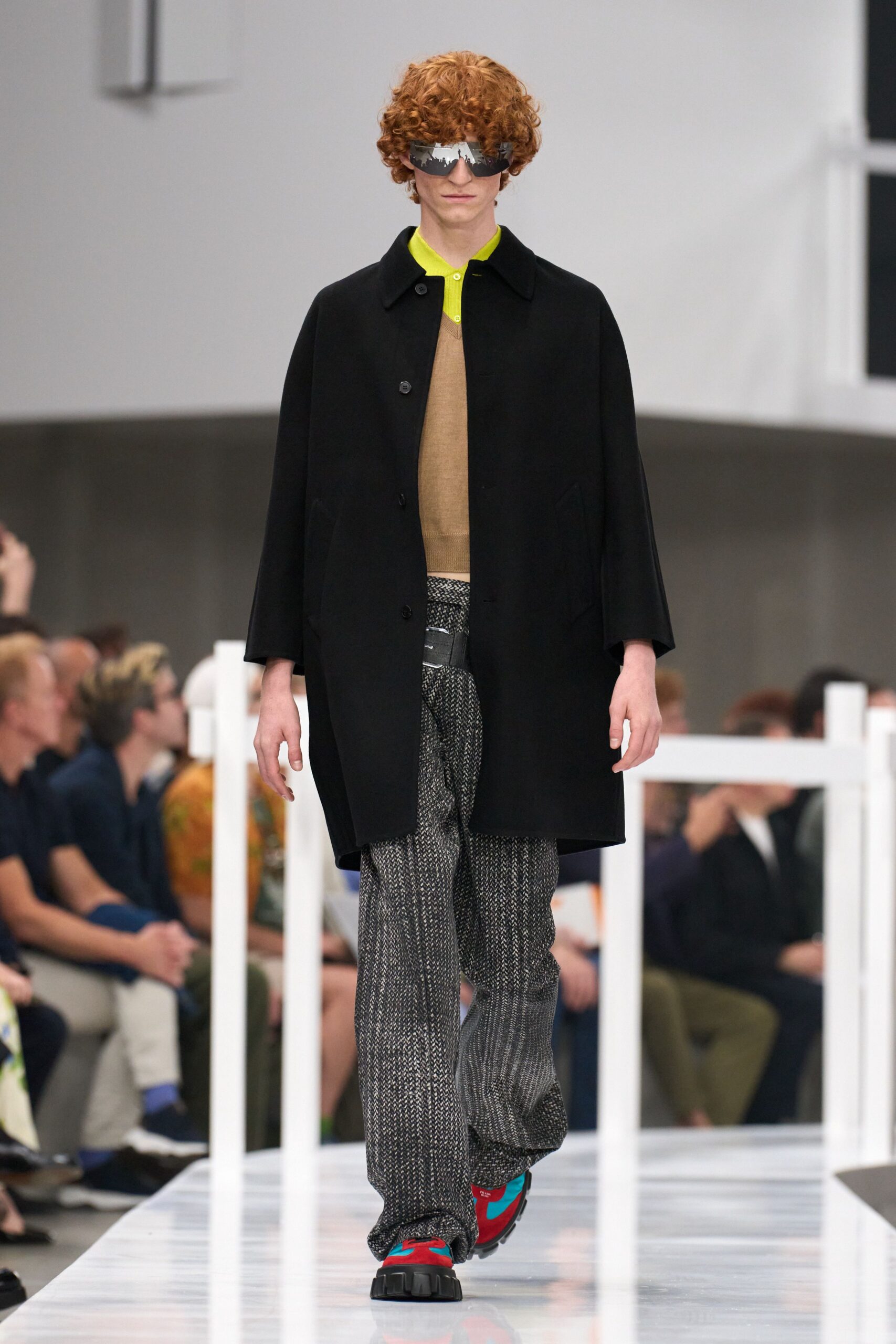 black coat yellow top gray pants