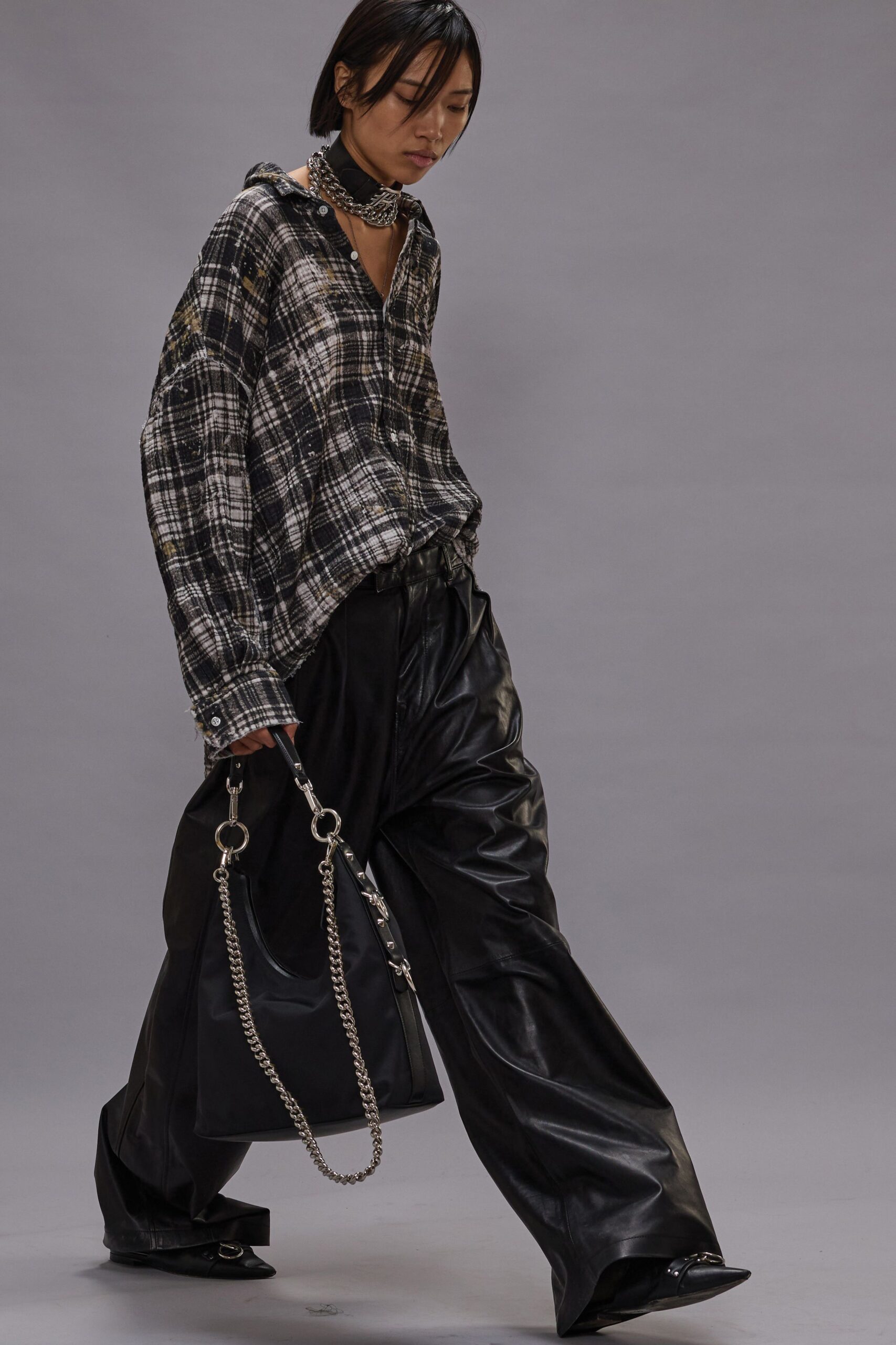 relaxed black leather pants and checked shirt
