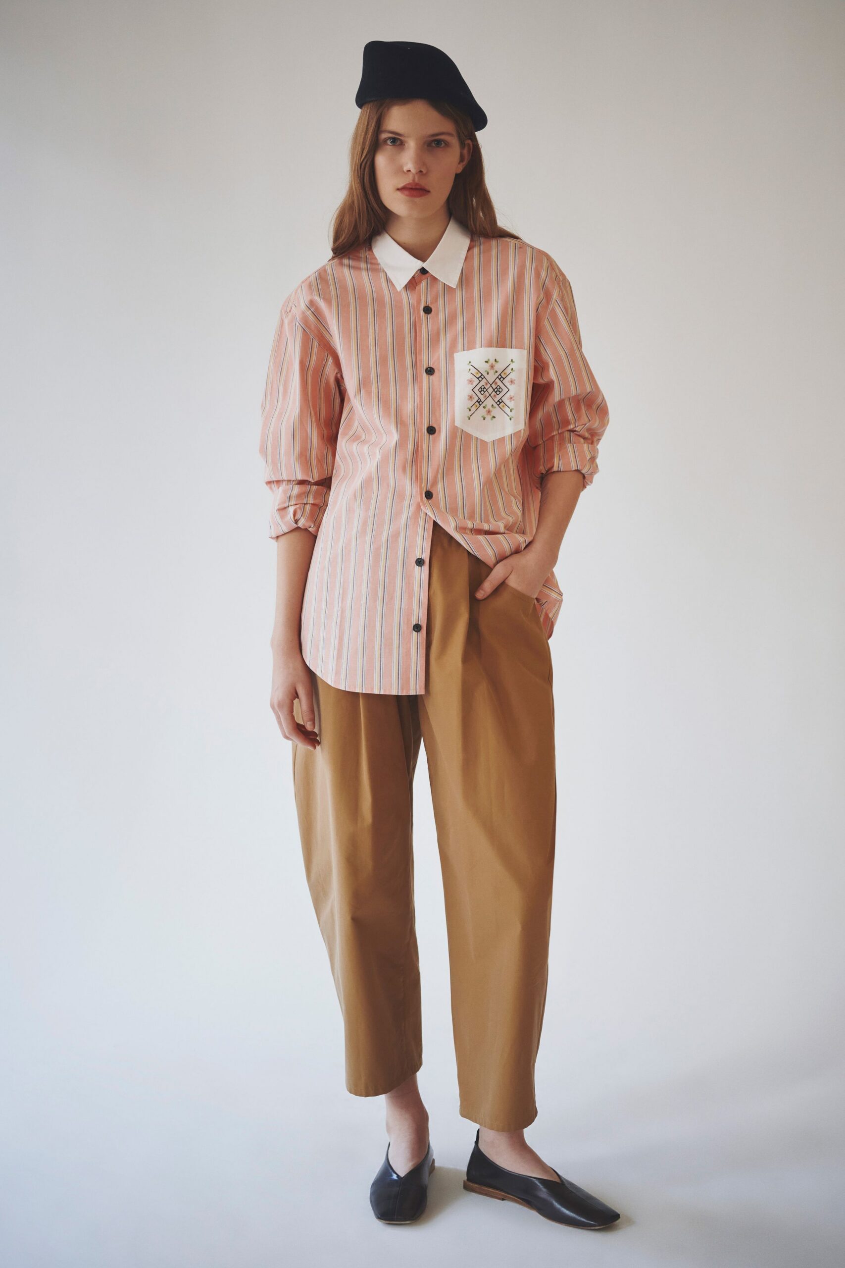 pink striped shirt with brown pants