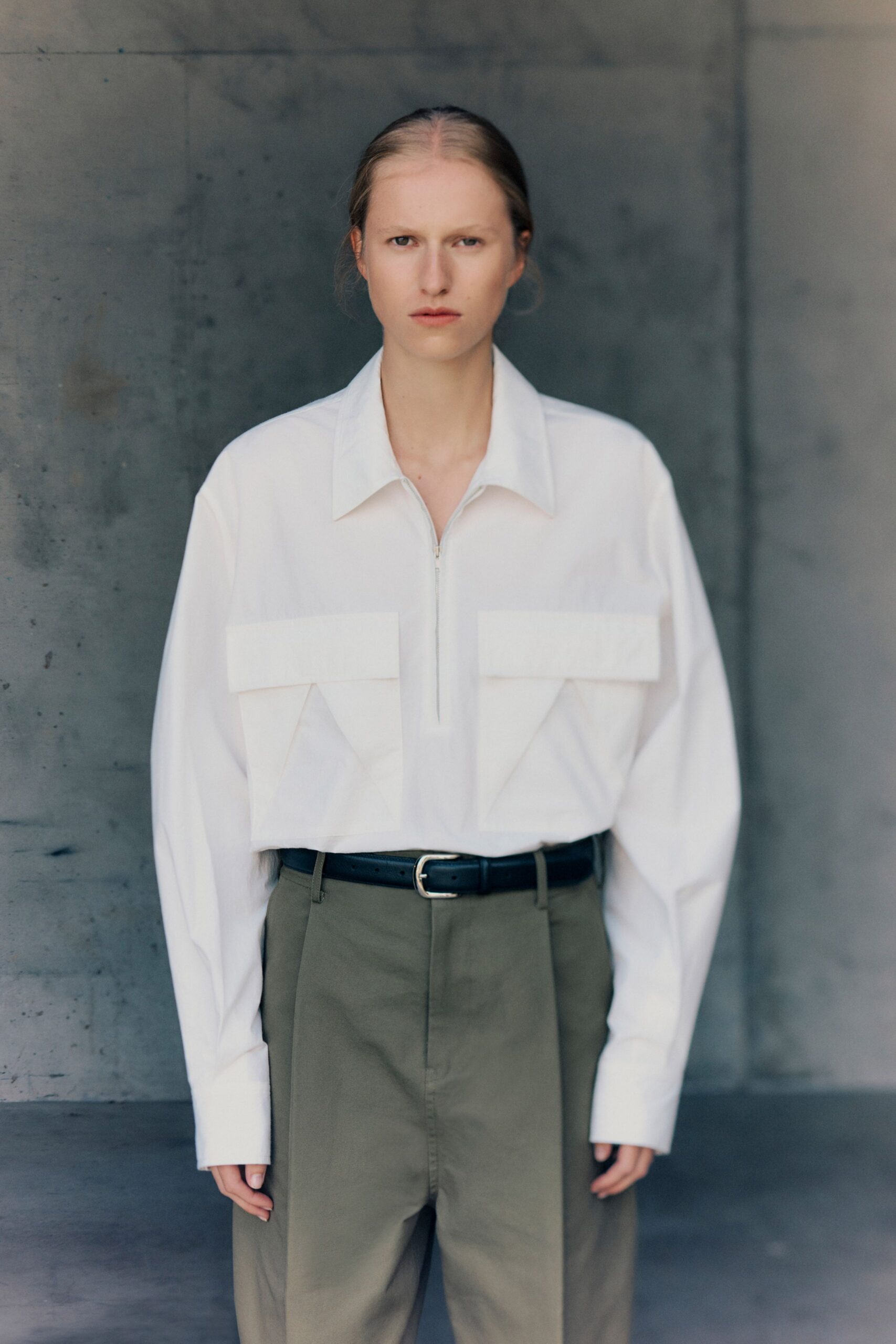 white relaxed shirt with green pants