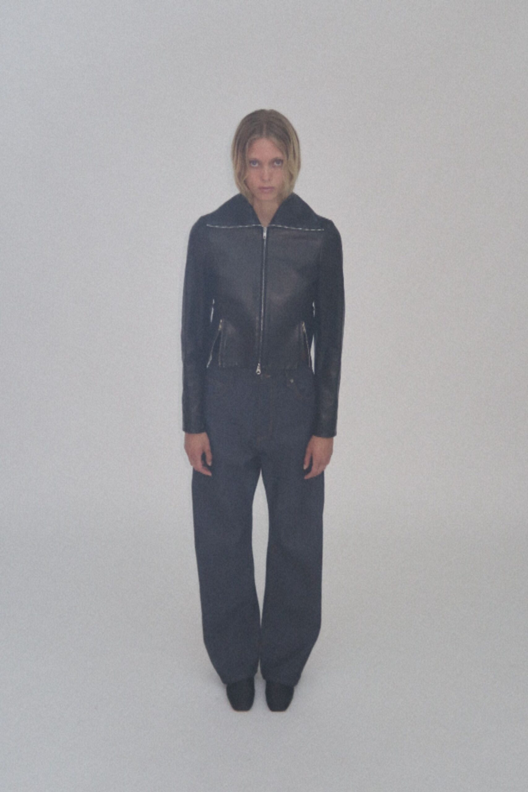 black leather jacket with gray pants